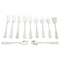 Set of five silver cake forks 
teaspoons w/ sugar scoops w/ trim on the handles