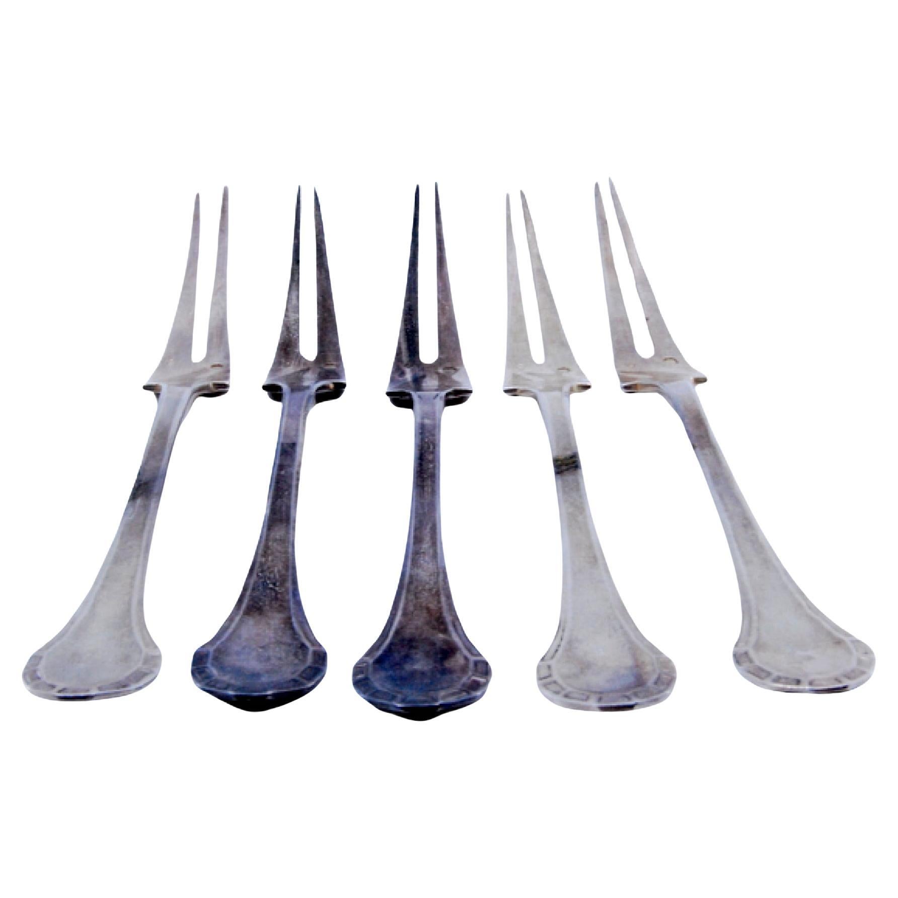 Set of five silver pickle forks with revealed handles