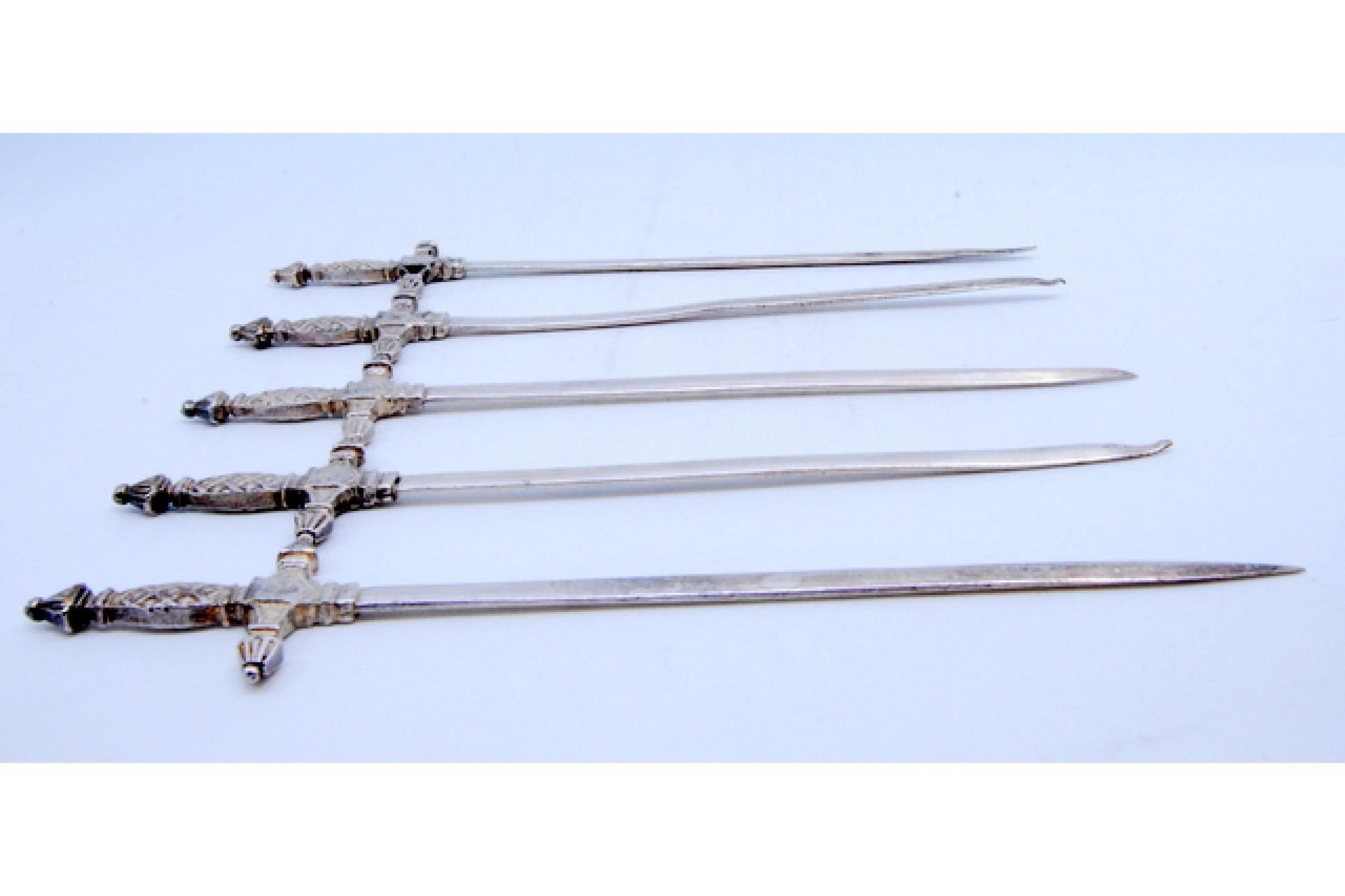 Set of five silver swords with relief on the hilt For Sale 1