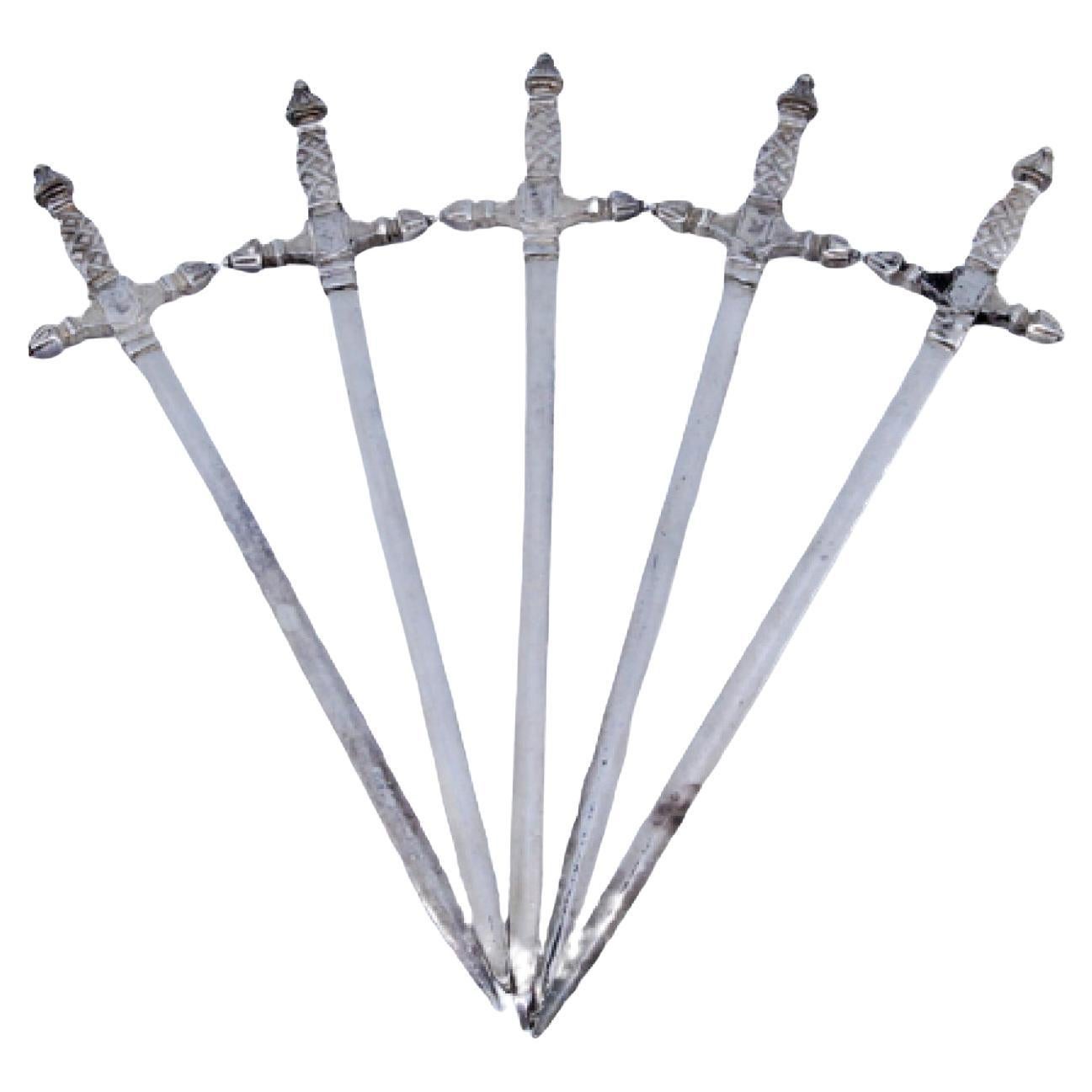 Set of five silver swords with relief on the hilt For Sale