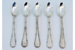 Set of five silver teaspoons with grooves along the handles