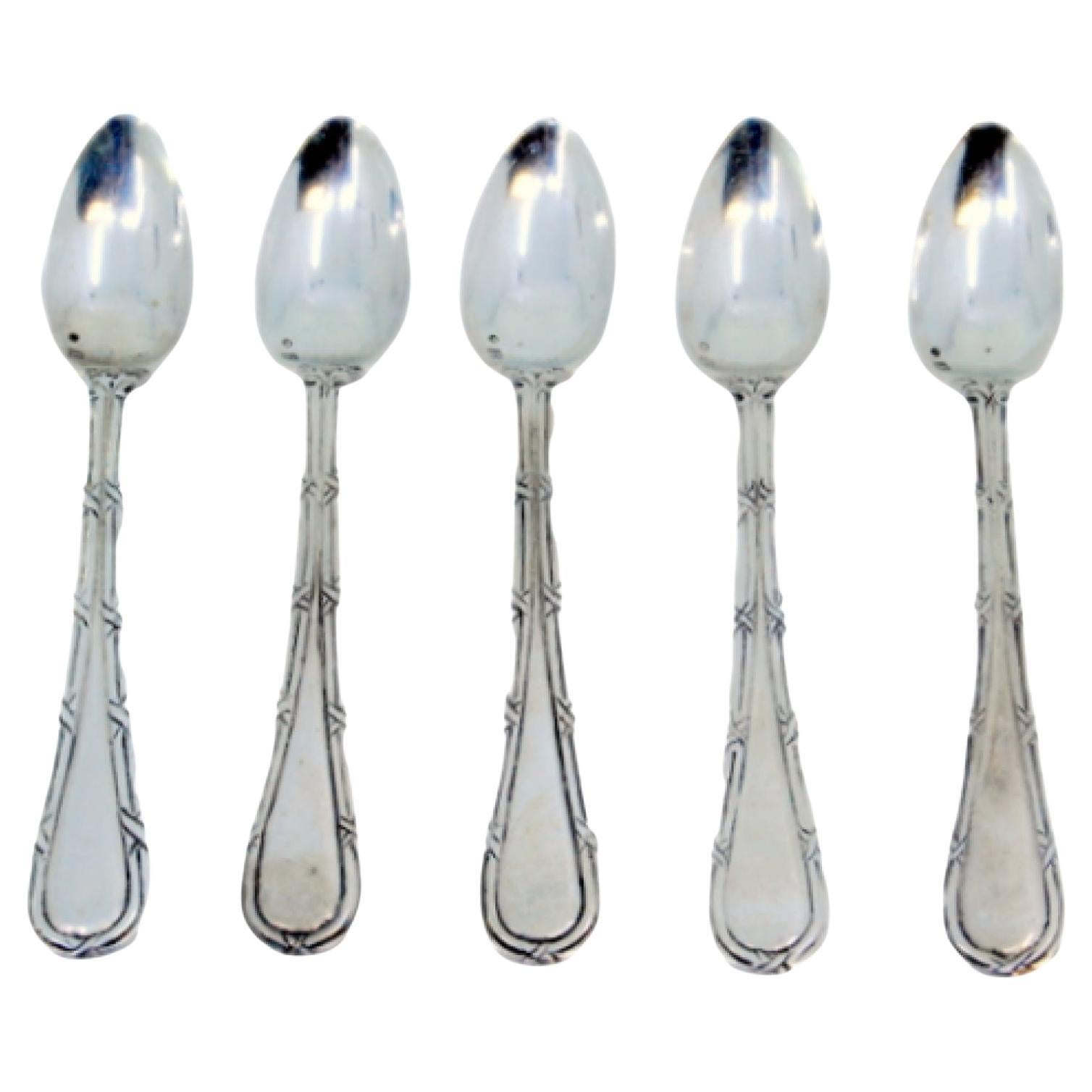 Set of five silver teaspoons with grooves along the handles