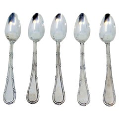 Set of five silver teaspoons with grooves along the handles