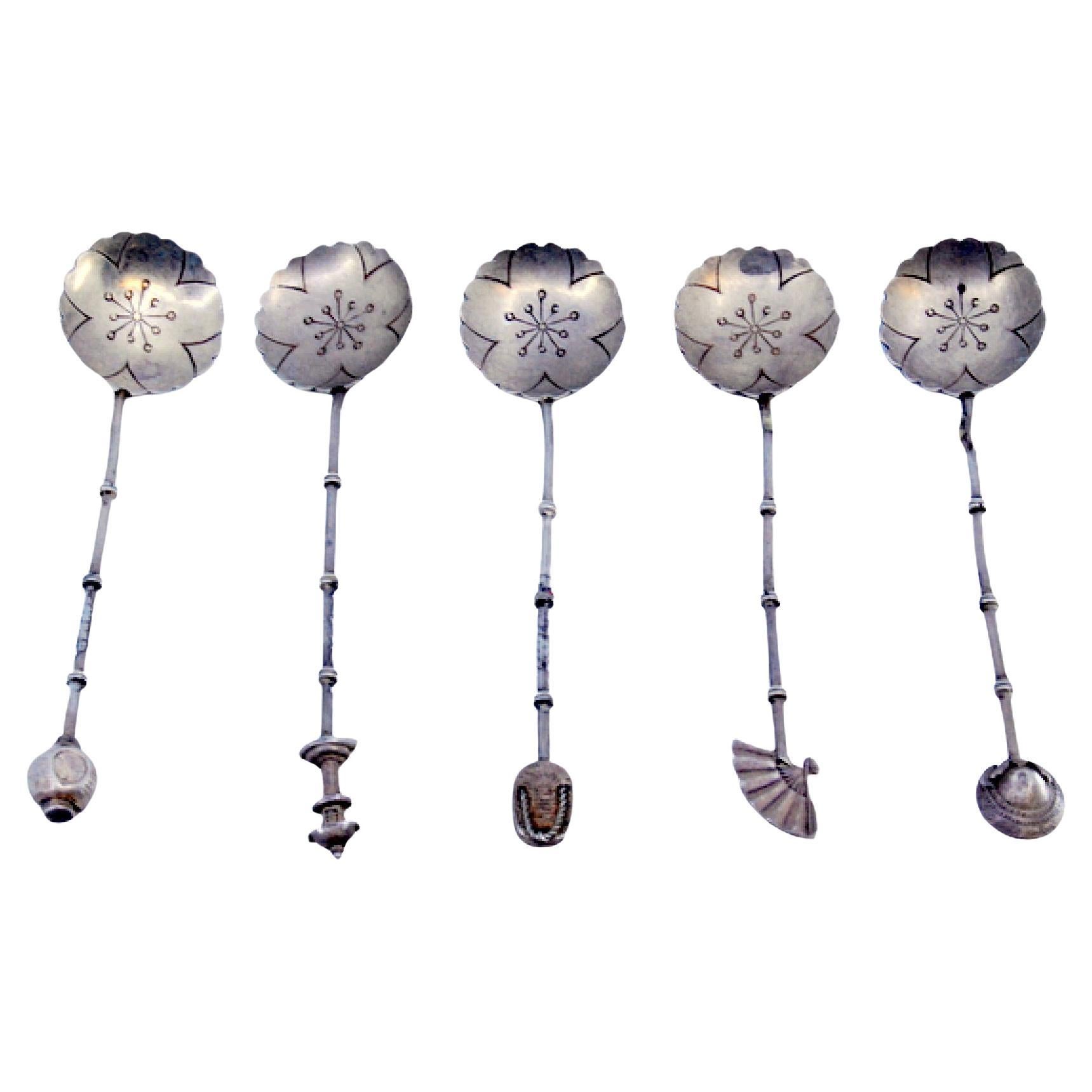 Set of five silver teaspoons with handle appliqués and cut-out shells