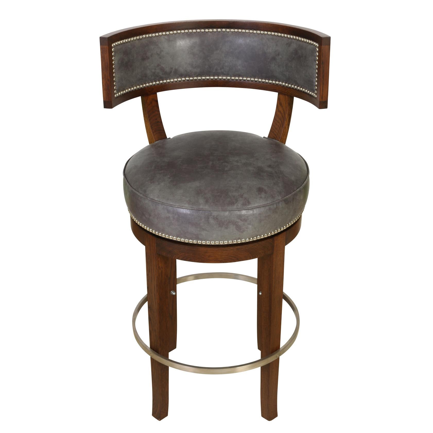 A set of five Soane bar stools in blue leather with nail head trim, curved back and metal ring stretcher. Seats swivel.