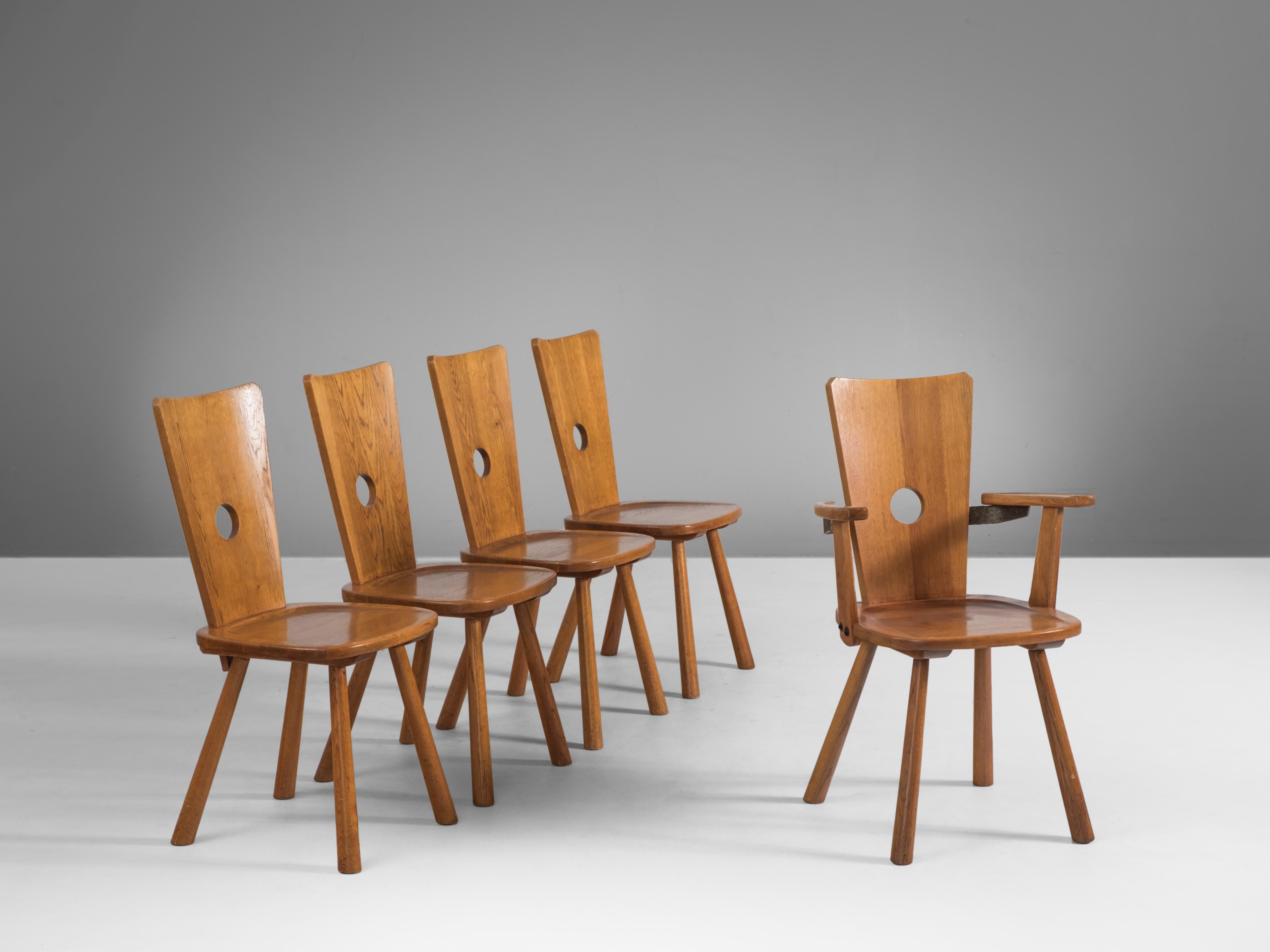 Set of five dining chairs, oak, the Netherlands, 1960s

Set of five solid oak chairs from Dutch origin. This set consists of four chairs and one armchair. The chairs have a distinct design with peculiar shapes and proportions. The design is rustic,