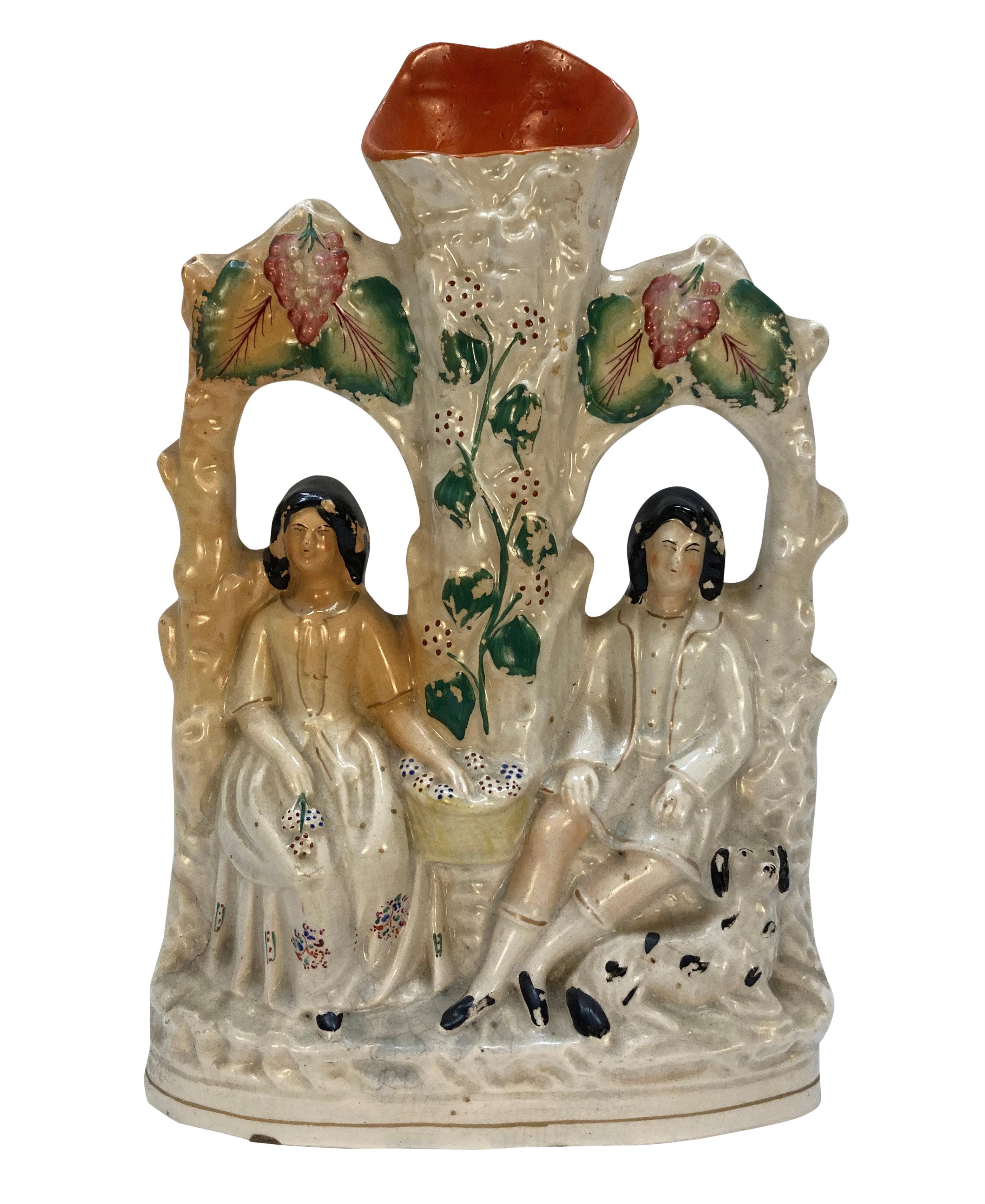 A set of five English, Staffordshire pottery flatback figures depicting couples, including two men and a fawn.