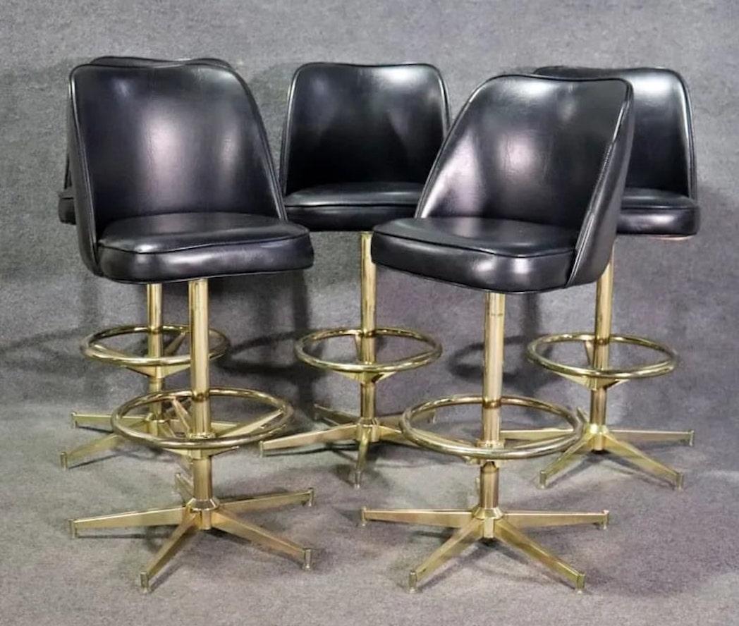 Set of five mid-century modern bar stools with polished brass colored bases and vinyl seats with backs.
Please confirm location NY or NJ