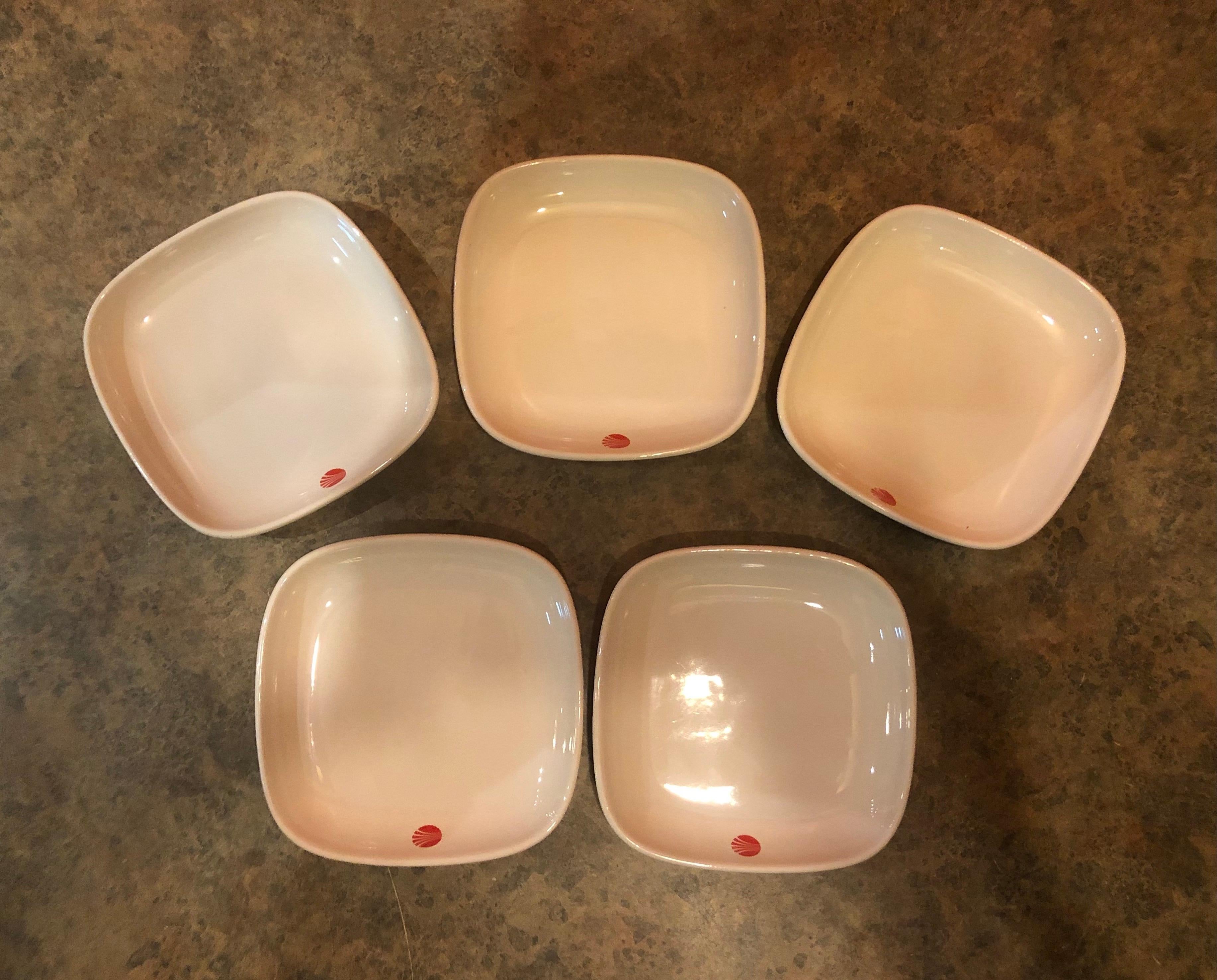 Fun set of five vintage continental airlines snack dishes, circa 1980s. They were used to serve first class passengers and are made of white stoneware with the red continental airlines logo. The snack plates are in excellent condition with no chips