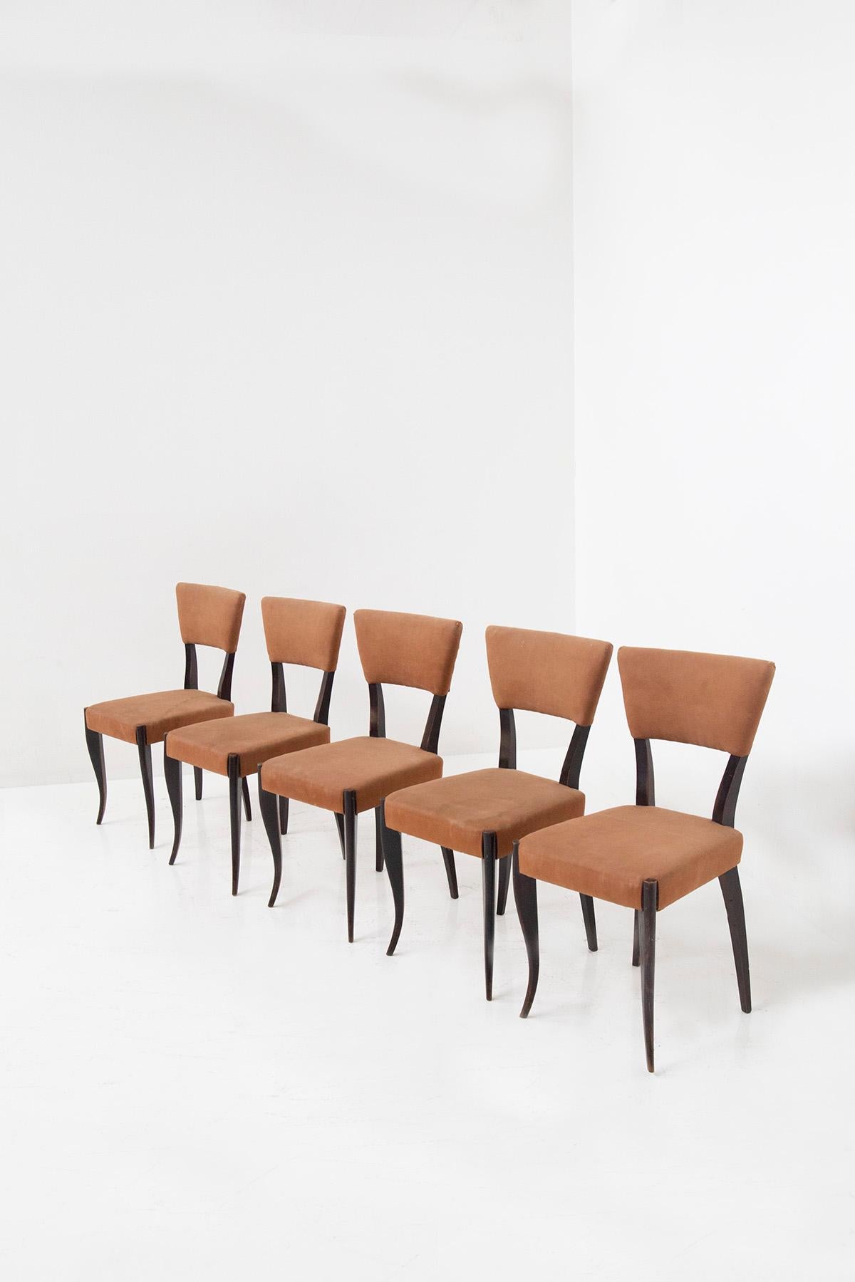 Step into a world of vintage allure with our extraordinary Set of Five Vintage Italian Chairs from the 1950s. Each chair is a captivating piece of history, meticulously crafted to embody the essence of mid-century Italian design.

The rich, dark