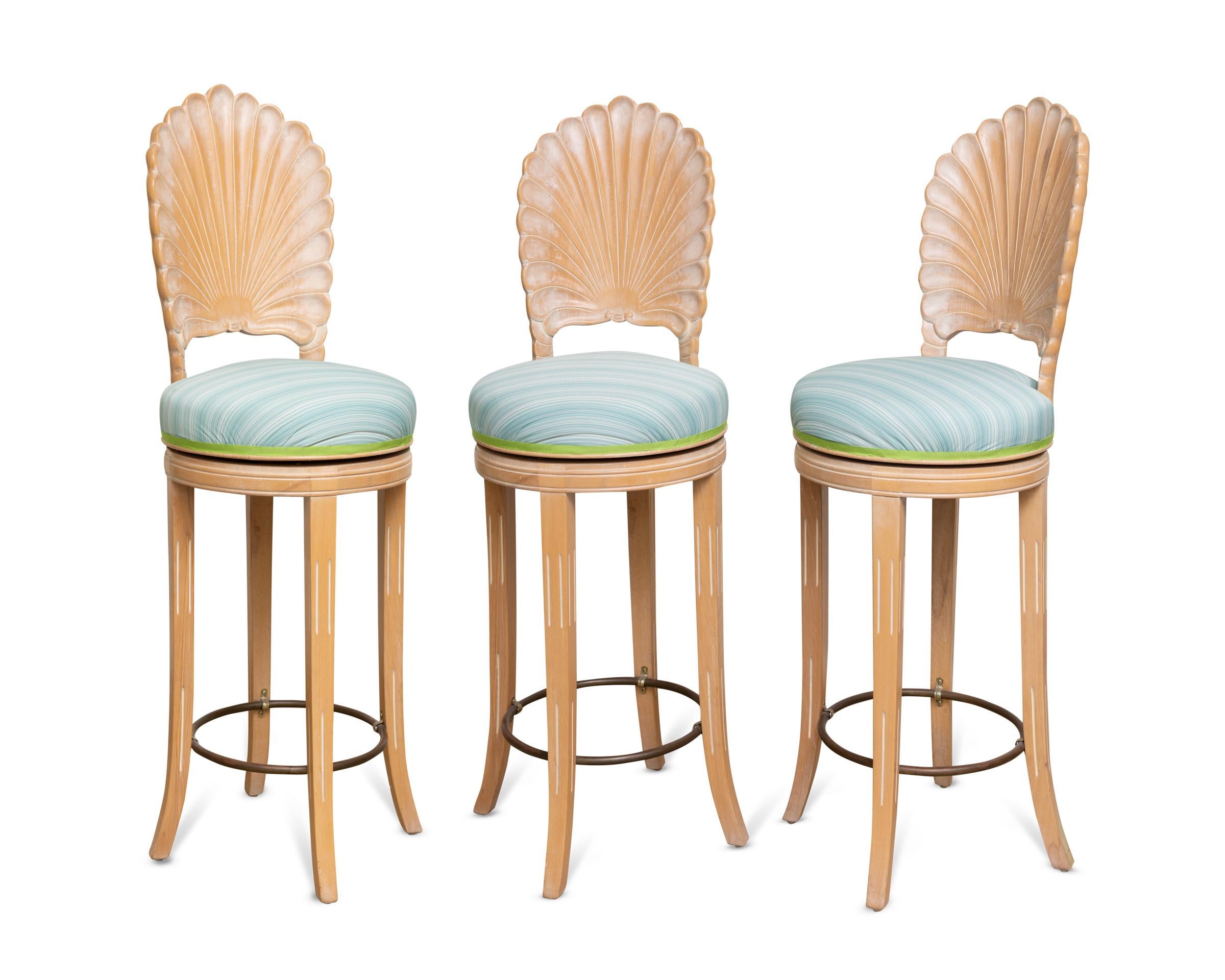 A set of five vintage shell back, cerused oak, swivel bar stools newly reupholstered in a Jim Thompson indoor-outdoor, blue striped fabric with green trim. A beautiful set of family friendly stools for a kitchen, family room or great room.