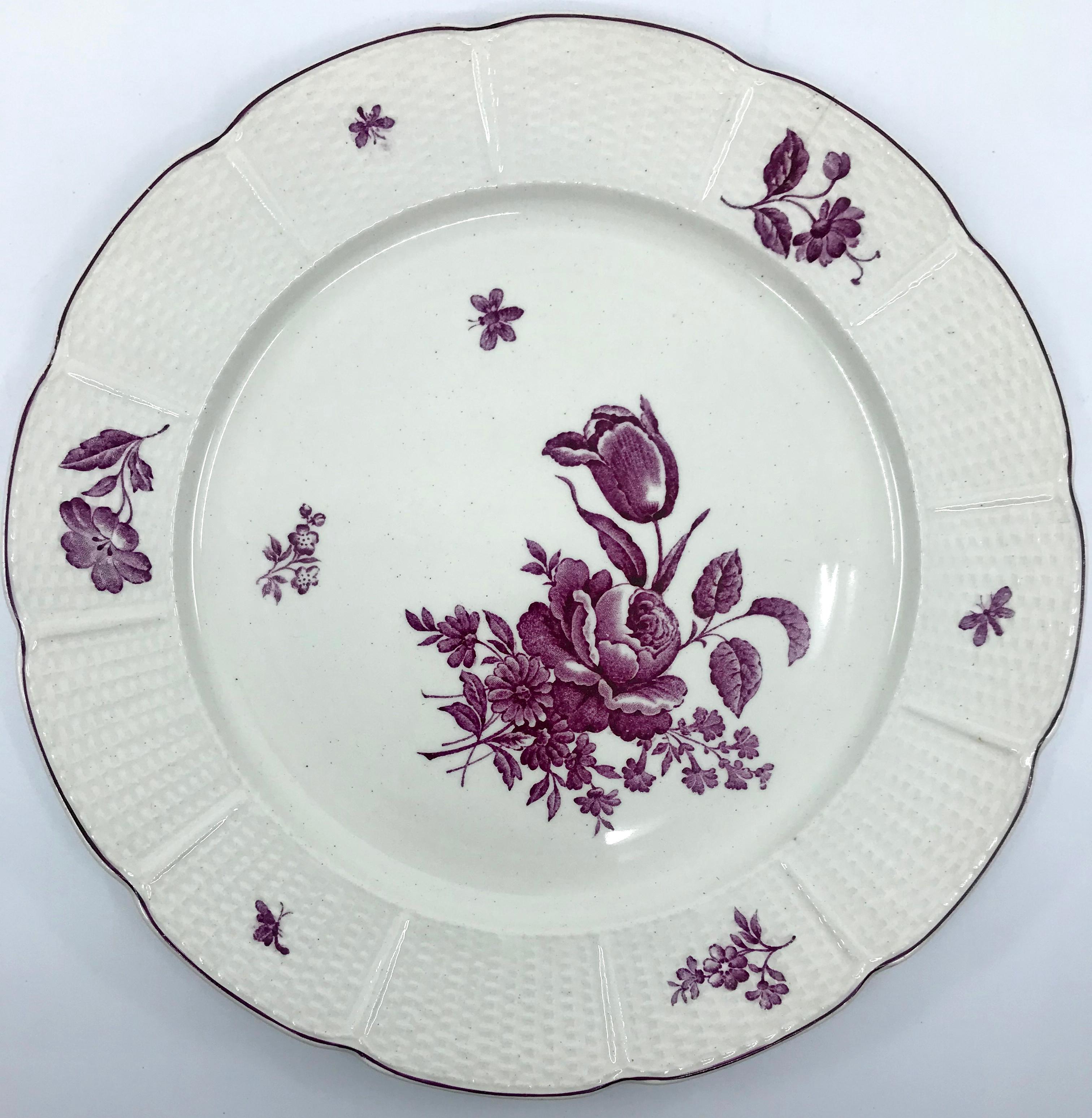 Set of five magenta and white Wedgwood floral plates. Wedgwood plates in the Frankenthal pattern with magenta floral sprays and butterflies and basket-weave border and foot. Stamped Wedgwood, made for the French market, England, early 20th century.