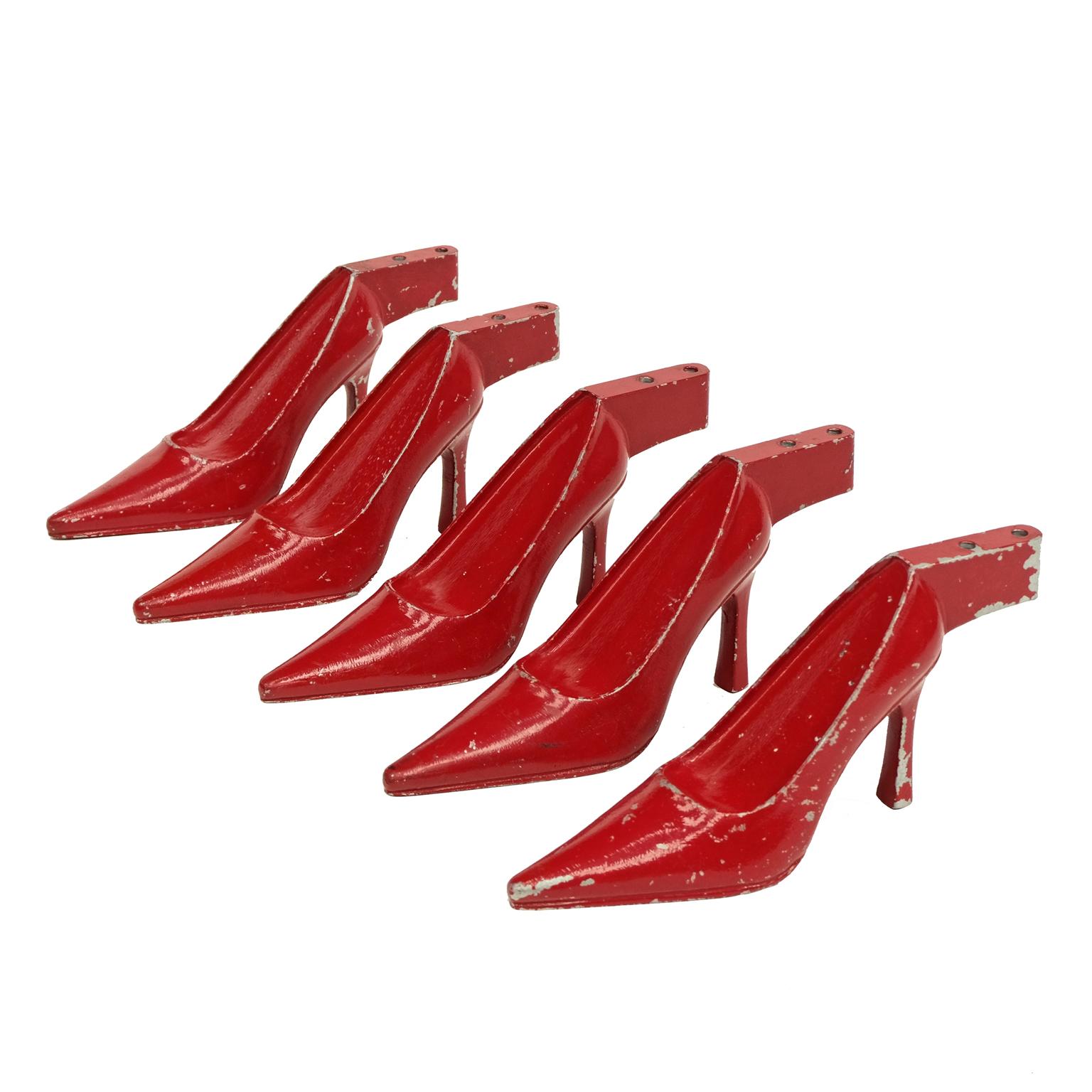 1950s Stiletto shoe displays. Red painted steel form designed and manufactured in the United Kingdom. Priced per shoe.

The shoes can be displayed as a group or individually. 

Signs of original age to the red painted surface.
Each shoe weighs an