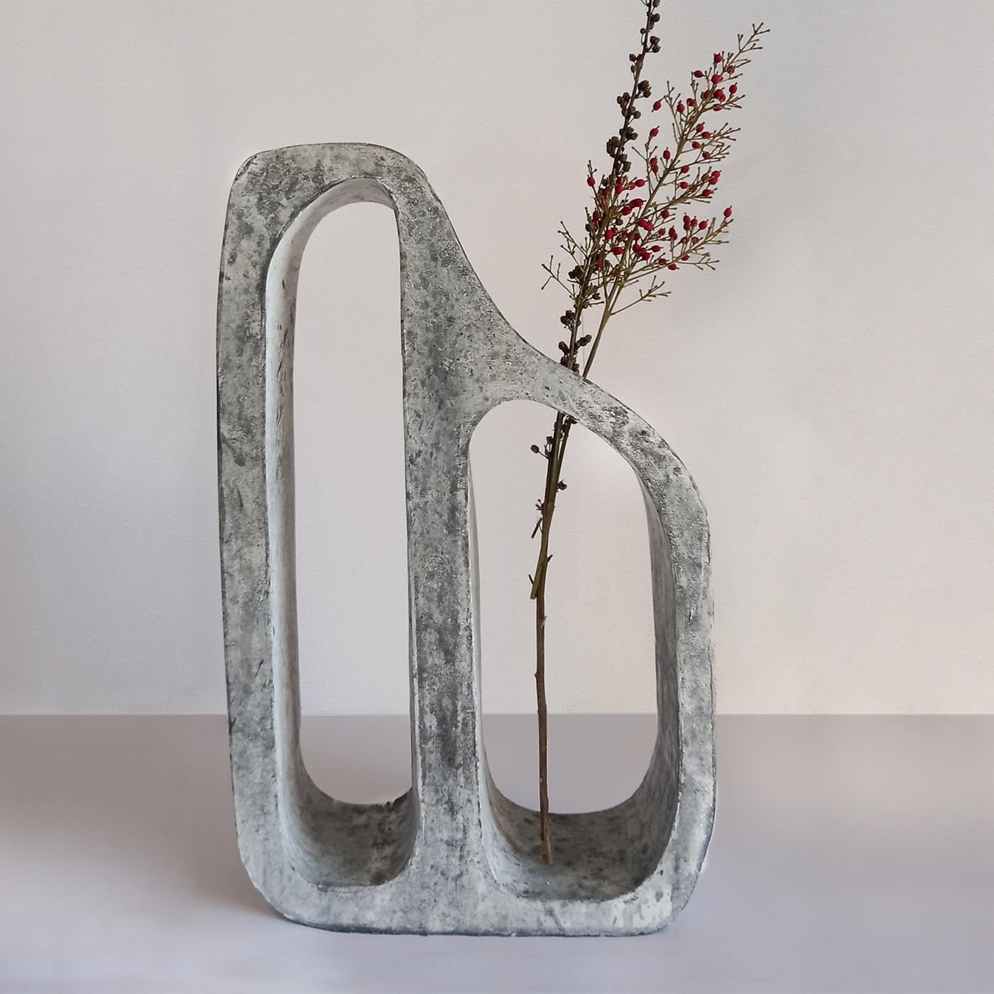 Flintstone Grey is distinguished by three pillars that connect an irregular curve line above. The irregular shape and the wide range of grey colors resemble natural stones (Dimensions: W 25 x D 7 x H 36). 
The second piece of the set refers to