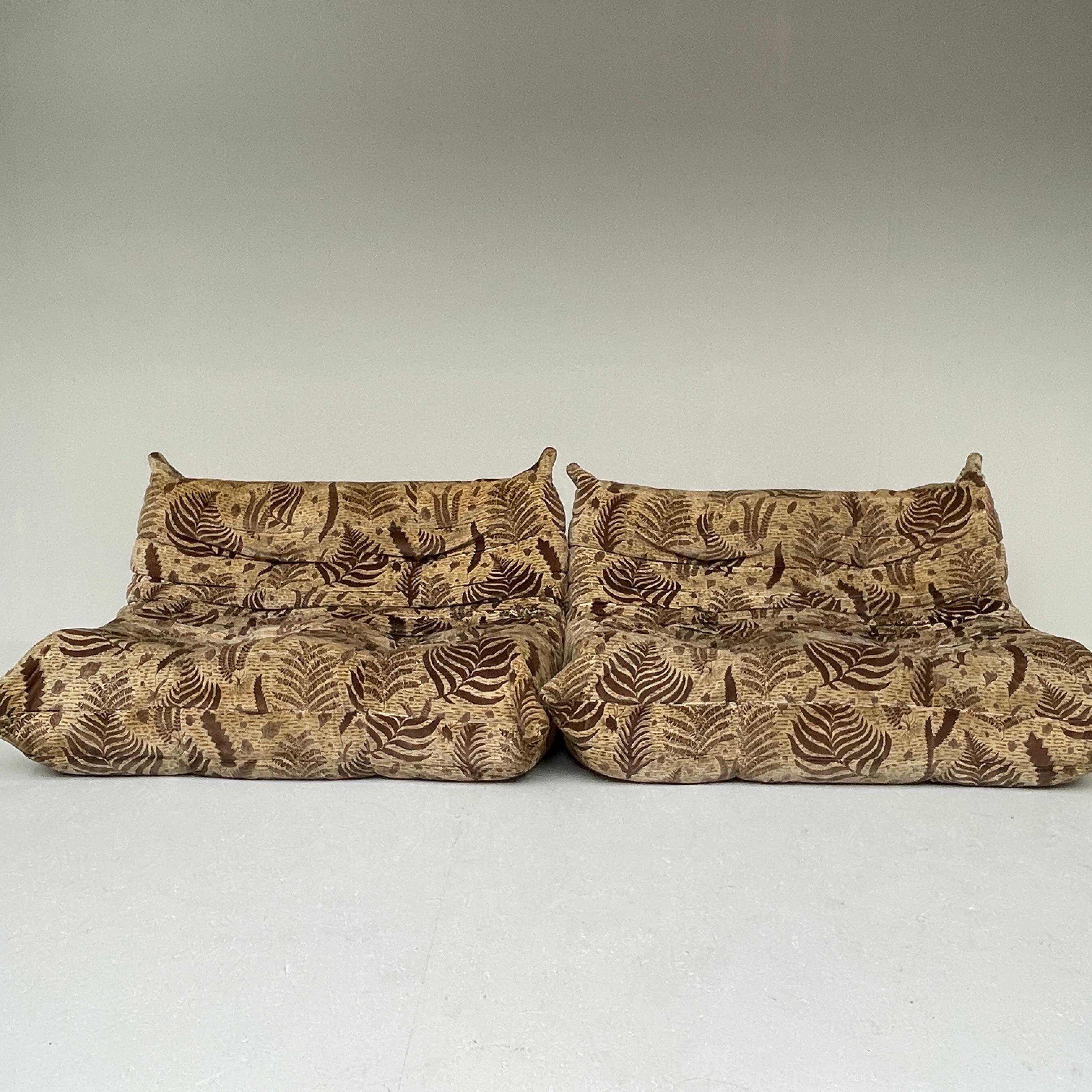 Designed in 1973 by Michel Ducaroy, instantly recognisable from its distinctive shape, the Togo has remained a cult classic for over 40 years.

One sofa has a green stain in the front of the seating. The other sofa has a water stain and a green