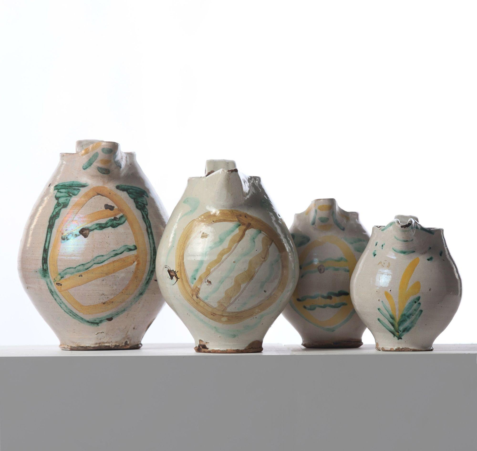 A rare graduated set of four Italian Majolica tin-glazed (lead glaze with a bit of tin oxide added) earthenware jugs, hand-painted with metal oxide enamel. Caltagirone, Sicily, circa 1780.   Dimensions noted below:
Jug 1:  15″ H x 9.88″ W
Jug 2: 