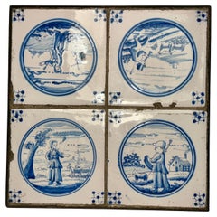 Ensemble de quatre carreaux de Delft bleus et blancs du XVIIIe siècle encadrés dans un cadre en fer personnalisé 