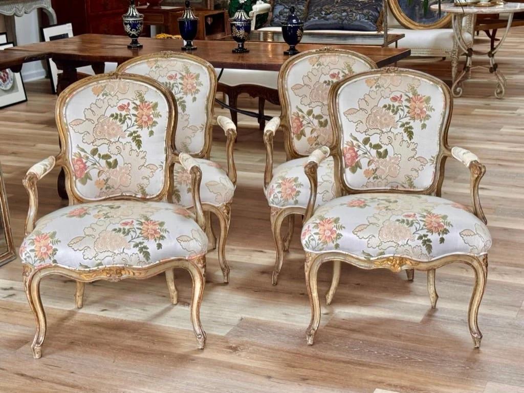 A Set of four outstanding 18th Century Louis XV pale green and gilt Fauteuils, armchairs, French.Height 34.25”h. x 24” w. x 20” d. SH 17.5”, 20” with added cushion. Original paint and gilding. Included custom made cream linen seat cushions.