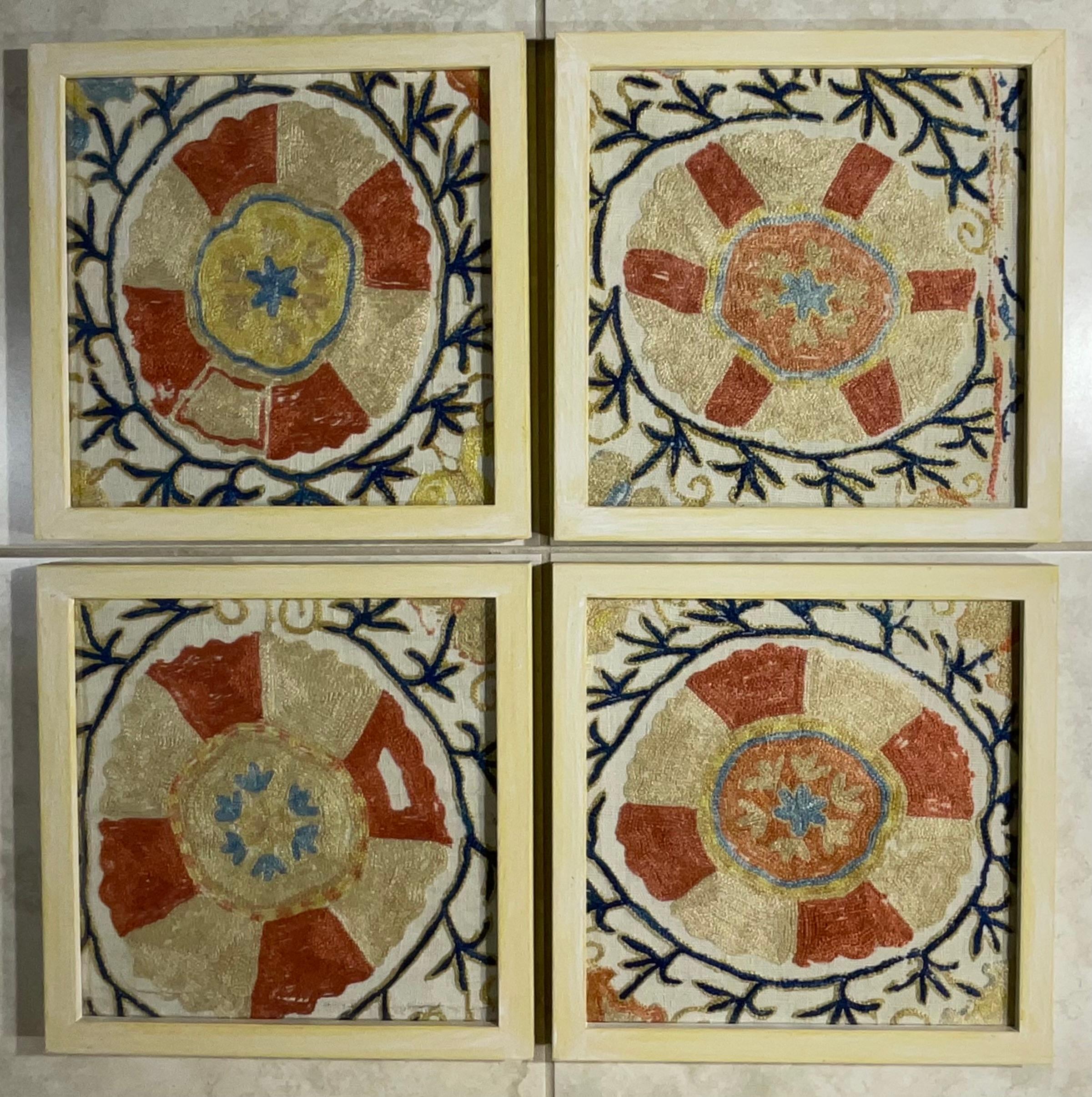 
This beautiful set of four Suzani embroidery features intricate geometric and floral patterns, showcasing traditional Uzbek craftsmanship. The vibrant colors and tight stitching suggest good quality. The hand-painted wooden frame complements the