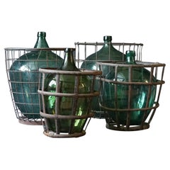 Set of Four 1920s French Green Demijohns, Lady Jeanne or Carboys in Metal Basket