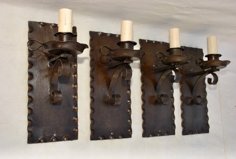 We also have our own line of wrought iron reproduction sconces and chandeliers, or we could do your own design
A very nice set of four rustic sconces, the patina is nicer in person, it has a dark brownish color.
   