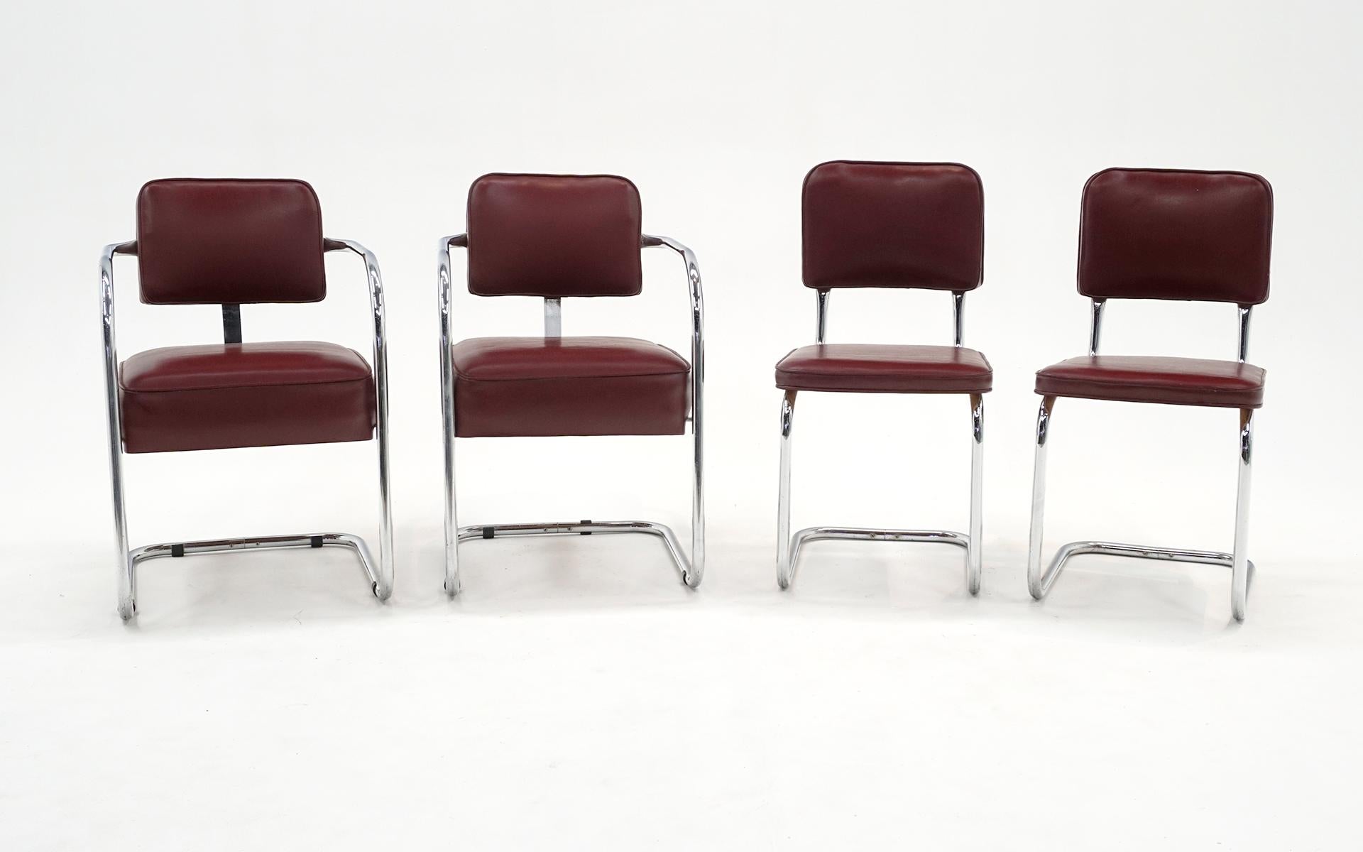 Set of 4 tubular chrome chairs, two with arms, two side chairs. We are not sure of the designer and manufacturer but these are similar to KEM Weber, Troy Sunshade. Lloyd, and Gilbert Rohde. Bauhaus / mid century. The arm chairs can function as small