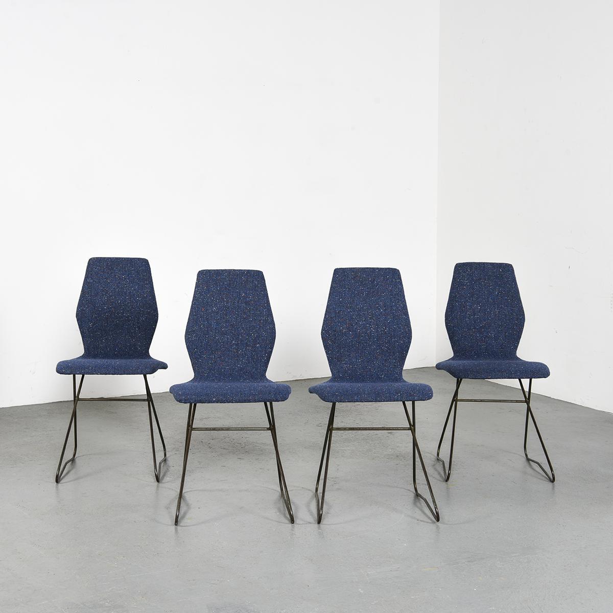 Set of four chairs by Louis Paolozzi : molded-pressed plywood shell padded and covered with a 50s spirit fabric, a red and white heather blue wool cloth resting on a black lacquered metal wire frame.

Manufacturer: Zol, circa 1956.