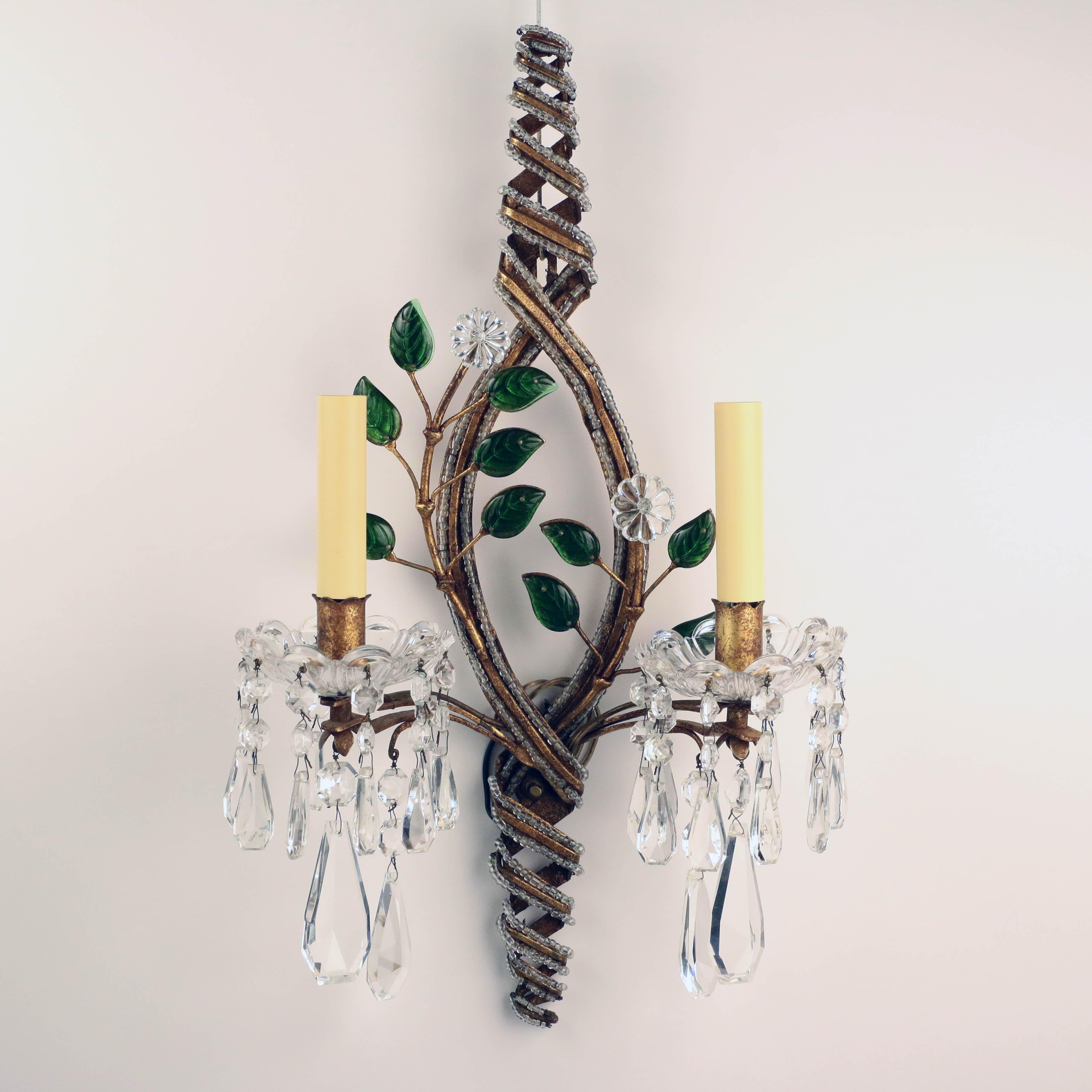 This unusual suite of wall sconces is unsigned but very much in the spirit of Baguès. Firstly, the emerald green leaves are gilt backed to give the extra sparkle. Secondly, the metal frame is Dutch gilt as is often the case with Baguès. Thirdly, the