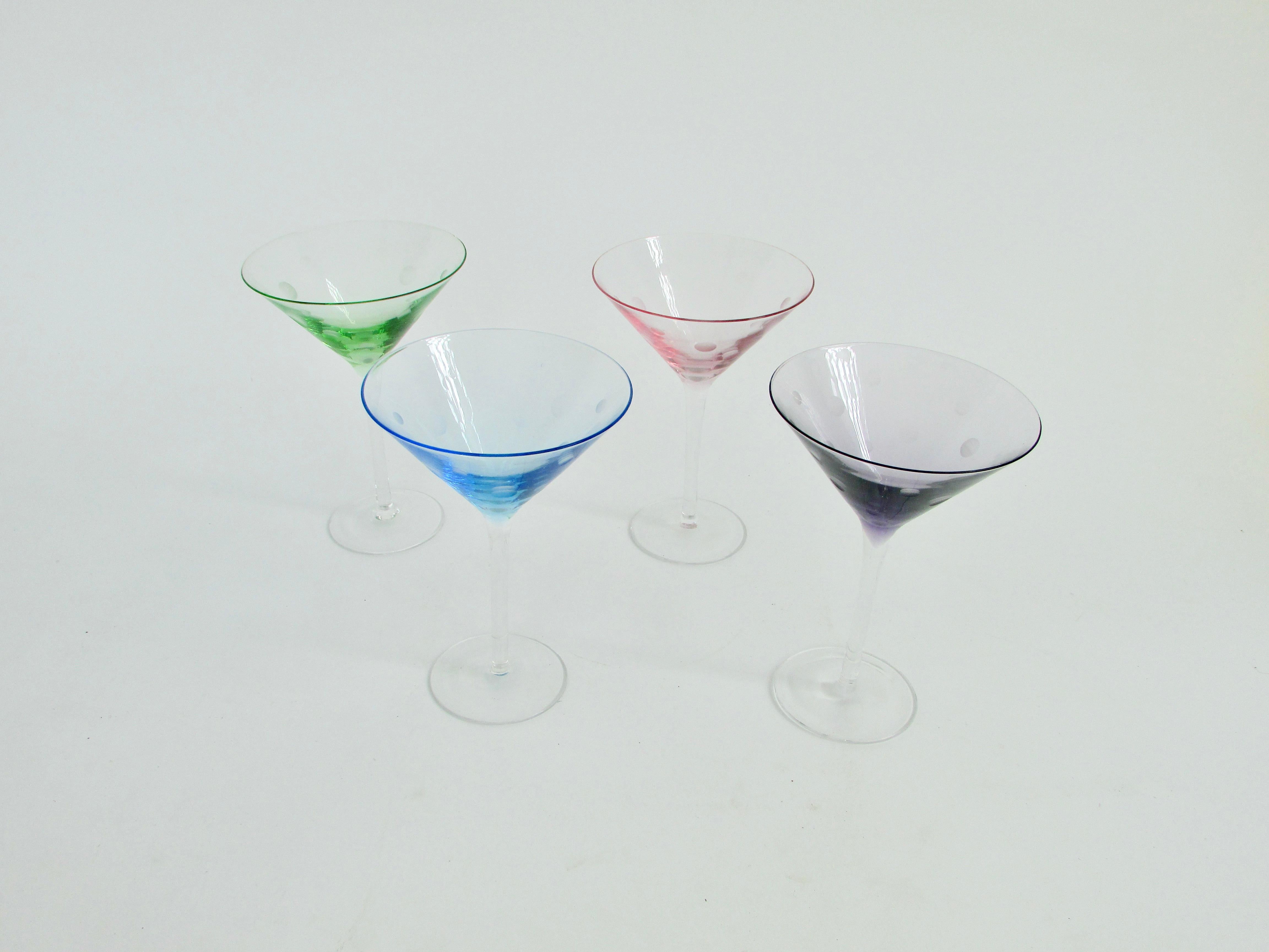 Set of four well balanced fun martini glasses . Each a different color from green , blue , pink and purple . Circle or bubble design etched into each one . 