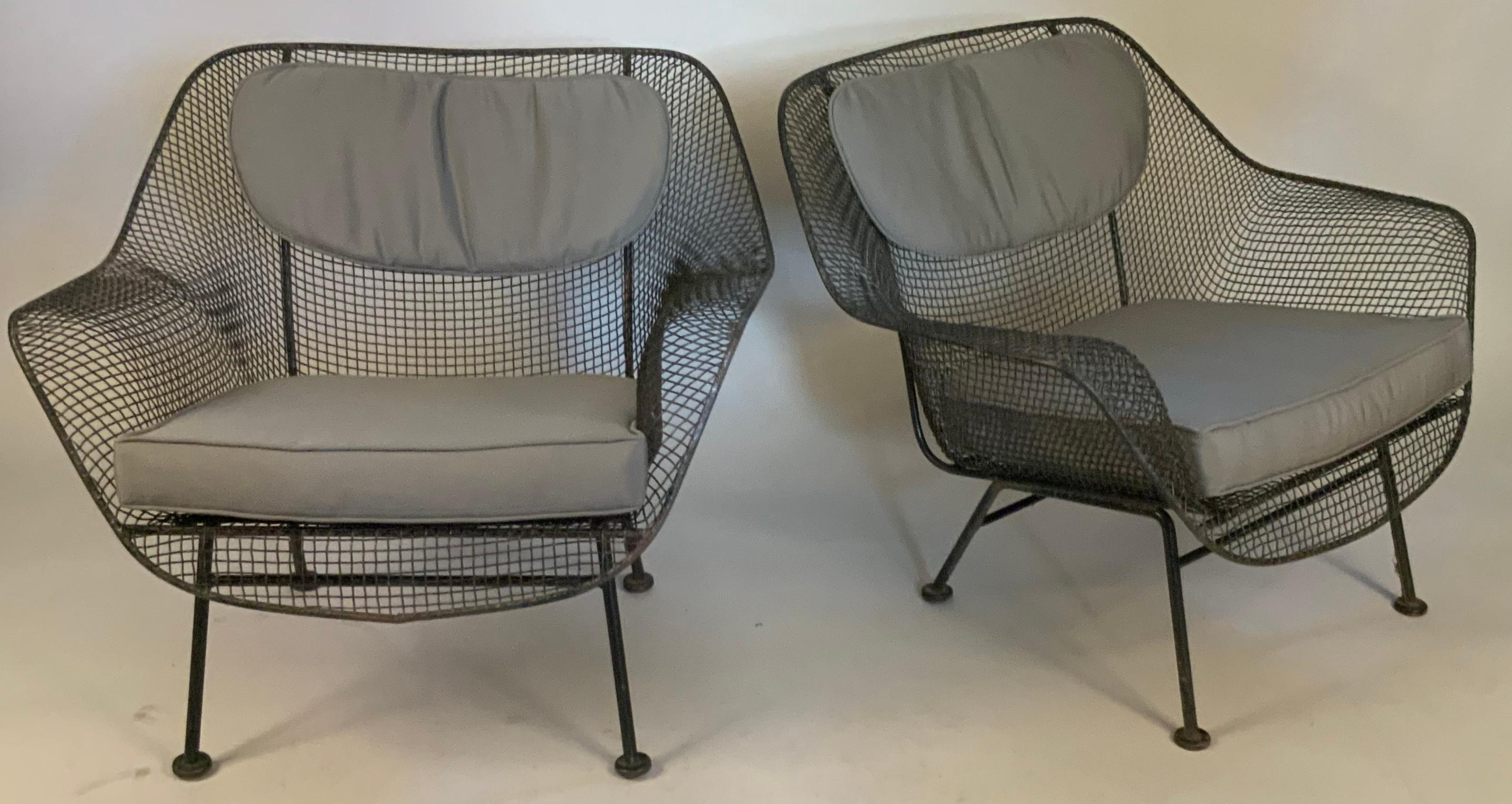 A set of Four of 1950's Sculptura wrought iron lounge chairs designed by Russell Woodard.

Woodard's Sculptura collection was made with wrought iron frames and woven steel mesh seats. These are the largest and most comfortable lounge chairs made