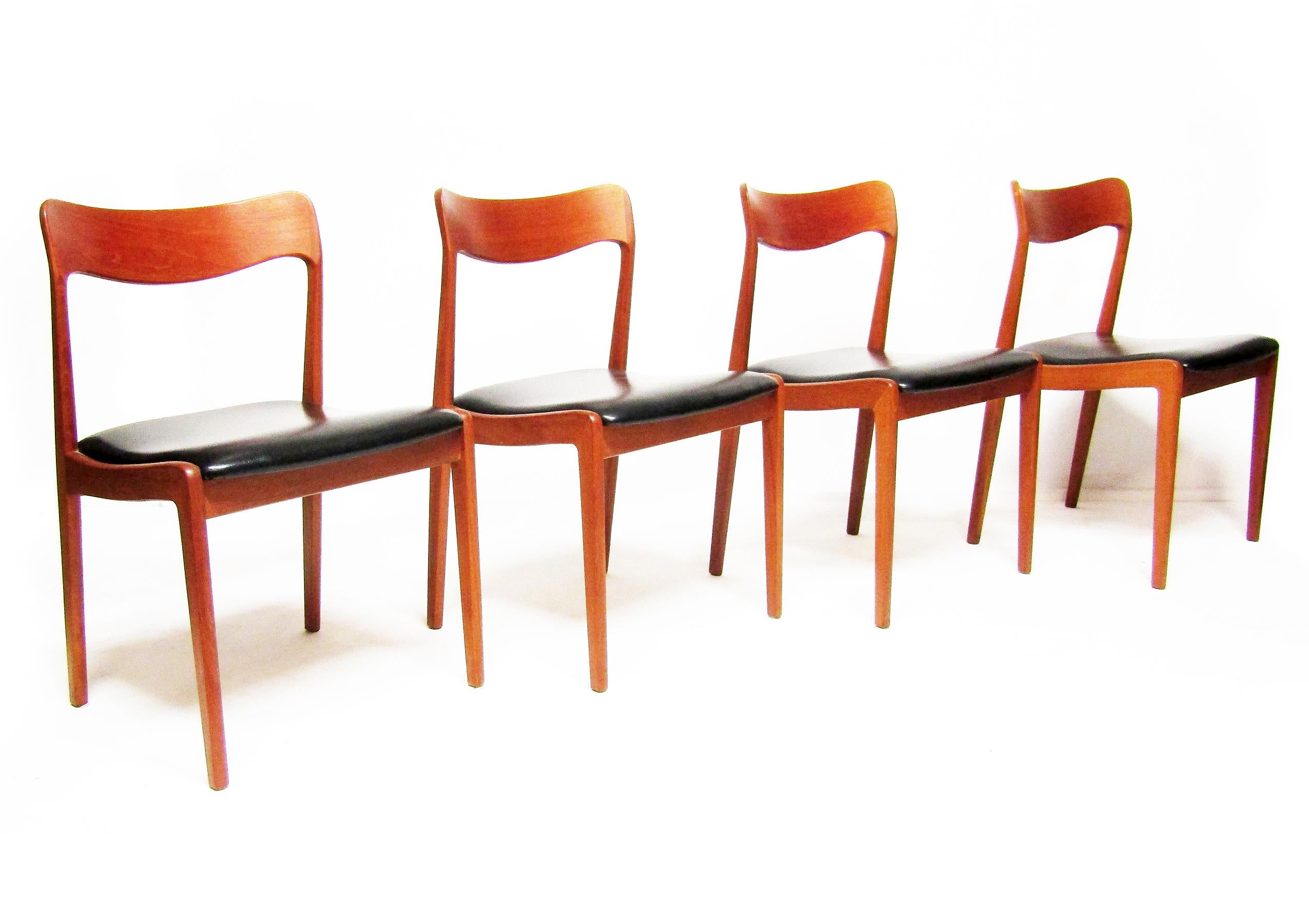 A set of four 1960s vintage dining chairs by Danish designer Henning Kjaernulf for Korup Stolefabrik.

Made from solid teak, the organically shaped backs and sculpted frames are ergonomic as well as graceful. Similar to Neils Moller designs, they