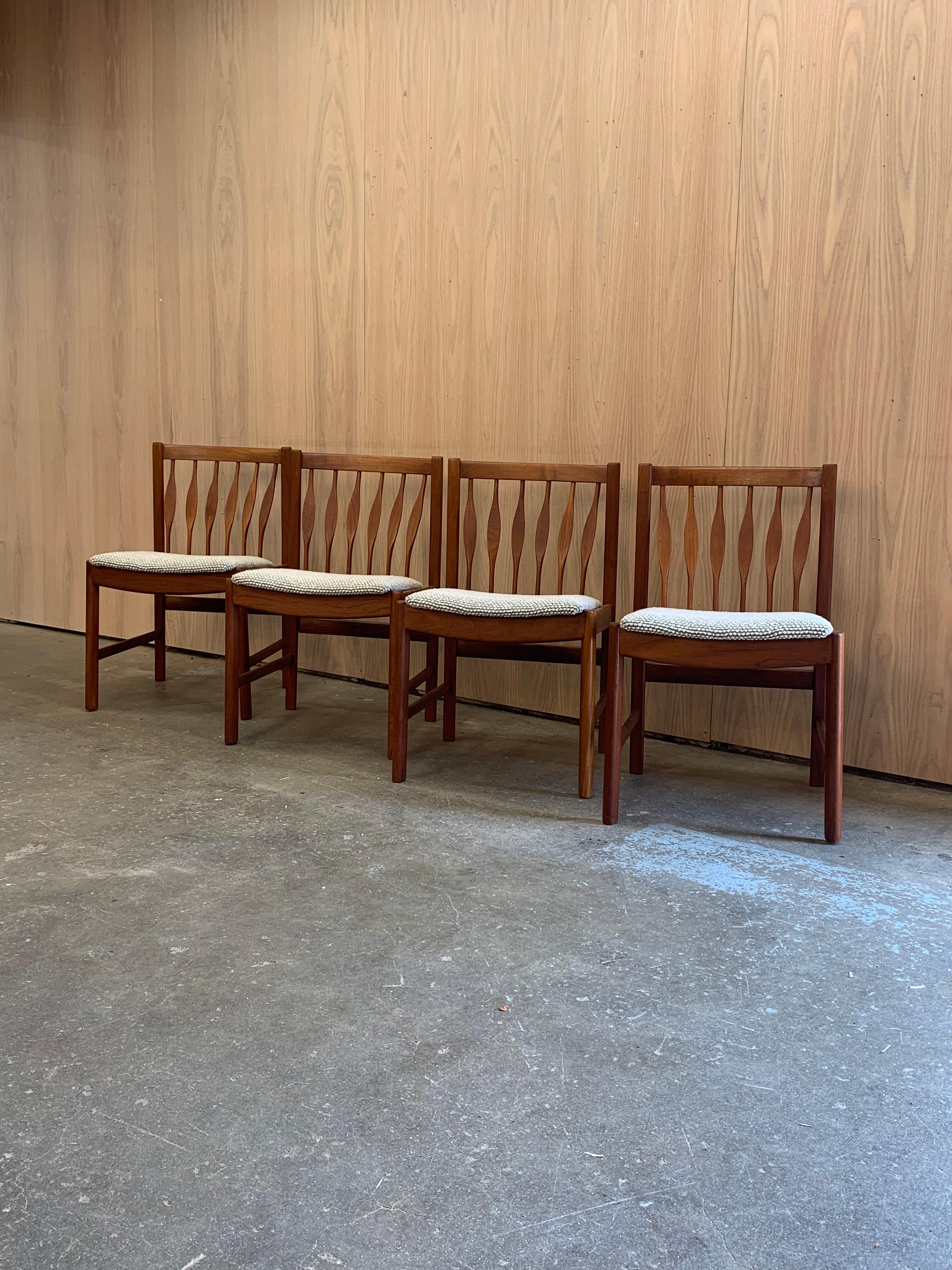 Set of four 1960s teak dining chairs by RS & Associates, crafted in Canada with elegant sculptural lines and signature curved teak slats. The frames have been freshly cleaned and polished by our team to bring out the warmth and grain of the solid