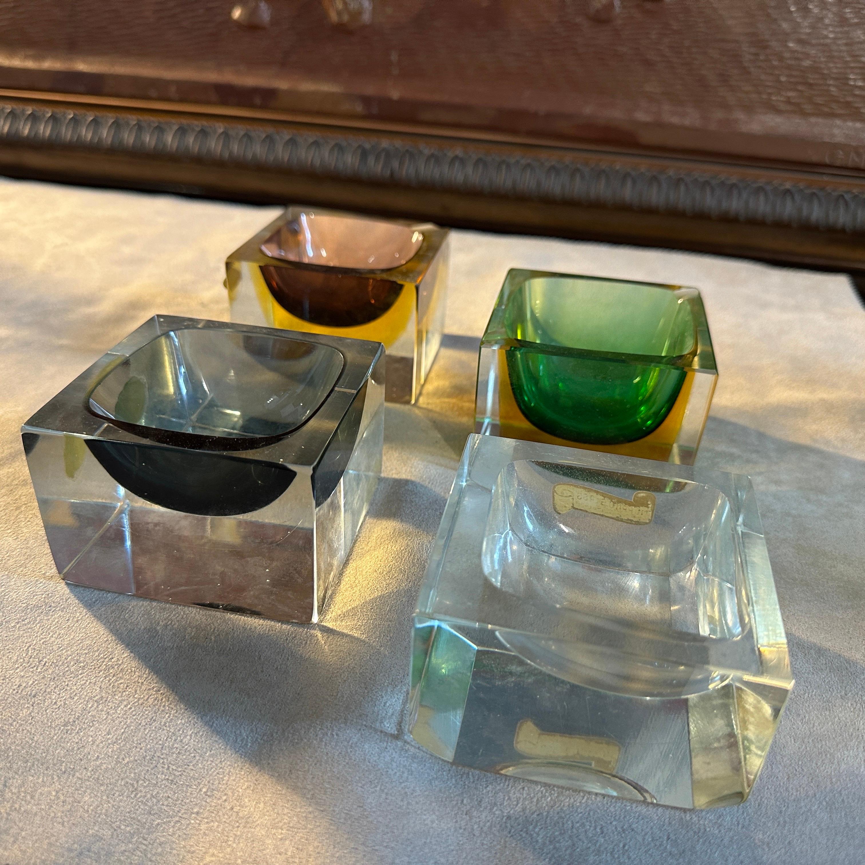 These Square Ashtrays designed and manufactured in Venice in the Seventies represents a harmonious fusion of form, color, and craftsmanship characteristic of the Murano glassmaking tradition.
Each ashtray in the set features the iconic Sommerso