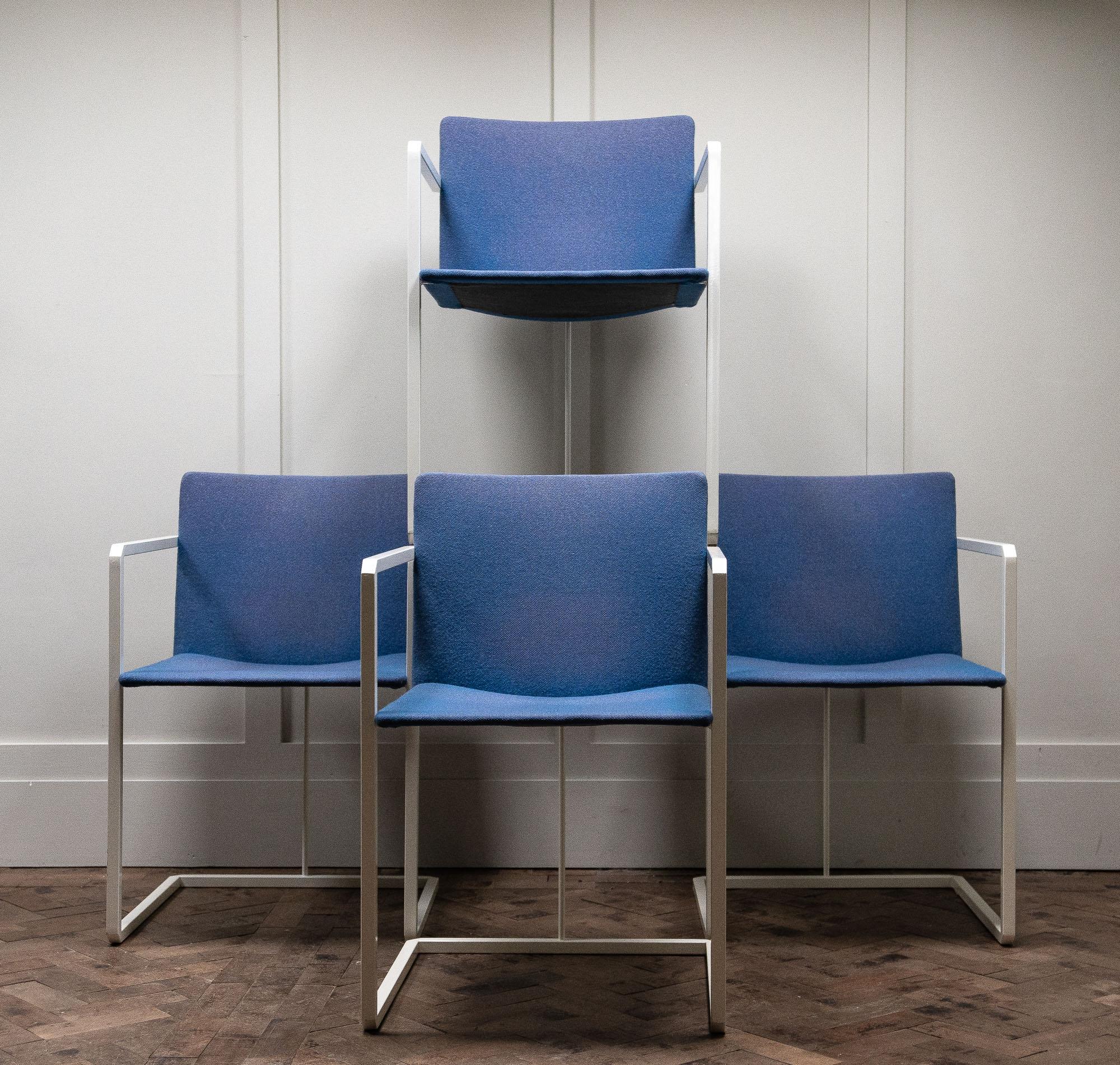 Set of four 1980s white and blue chairs, with a metal steel frame and a ply seat frame covered in blue upholstery.

Measures: Height 77cm
Seat height 44cm
Width 50cm
Depth 48cm.
 