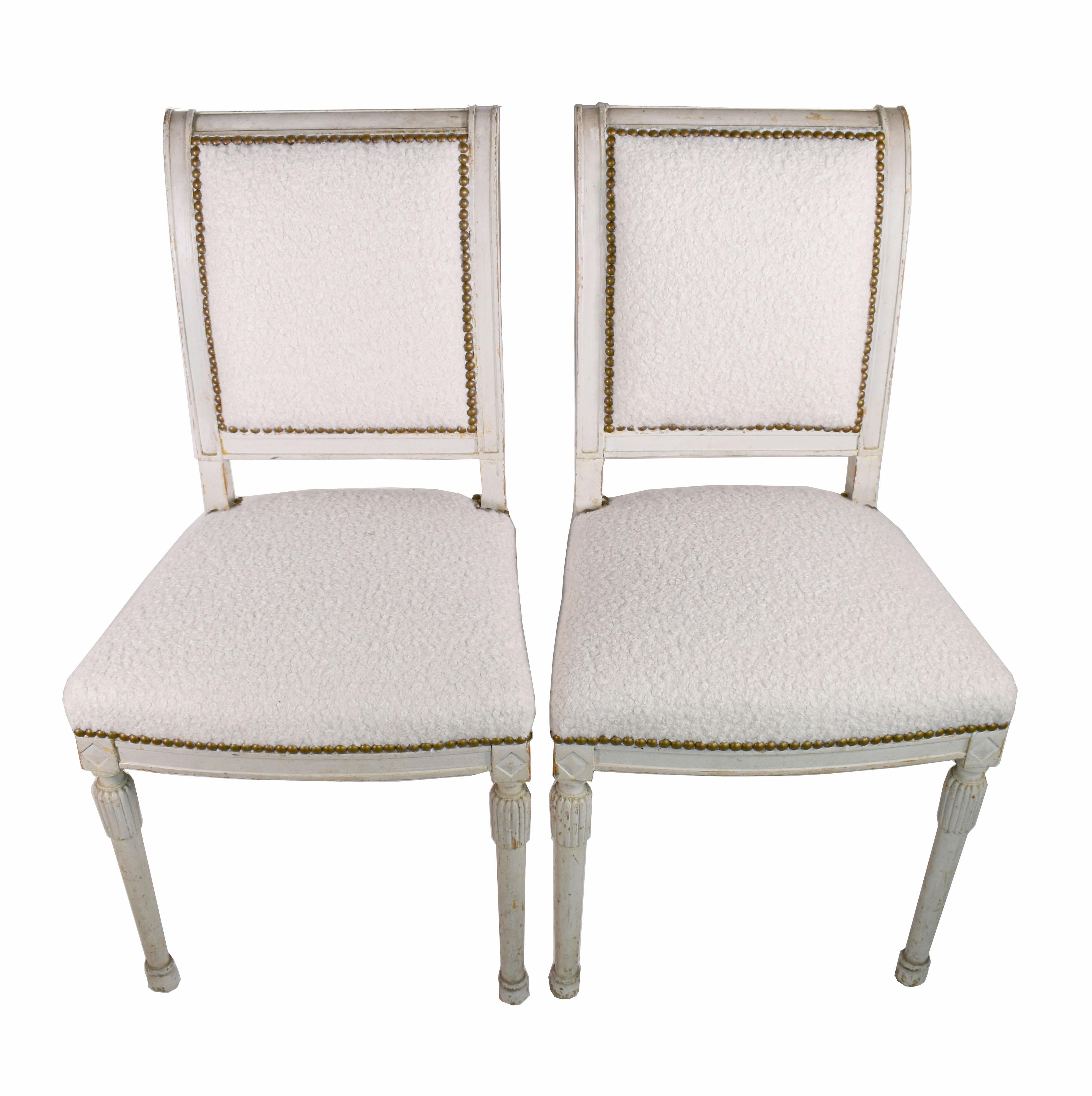 19th century Directoire chairs neoclassical carving detail and weathered off-white patina. Two armchairs and two side chairs upholstered in off-white textured fabric.