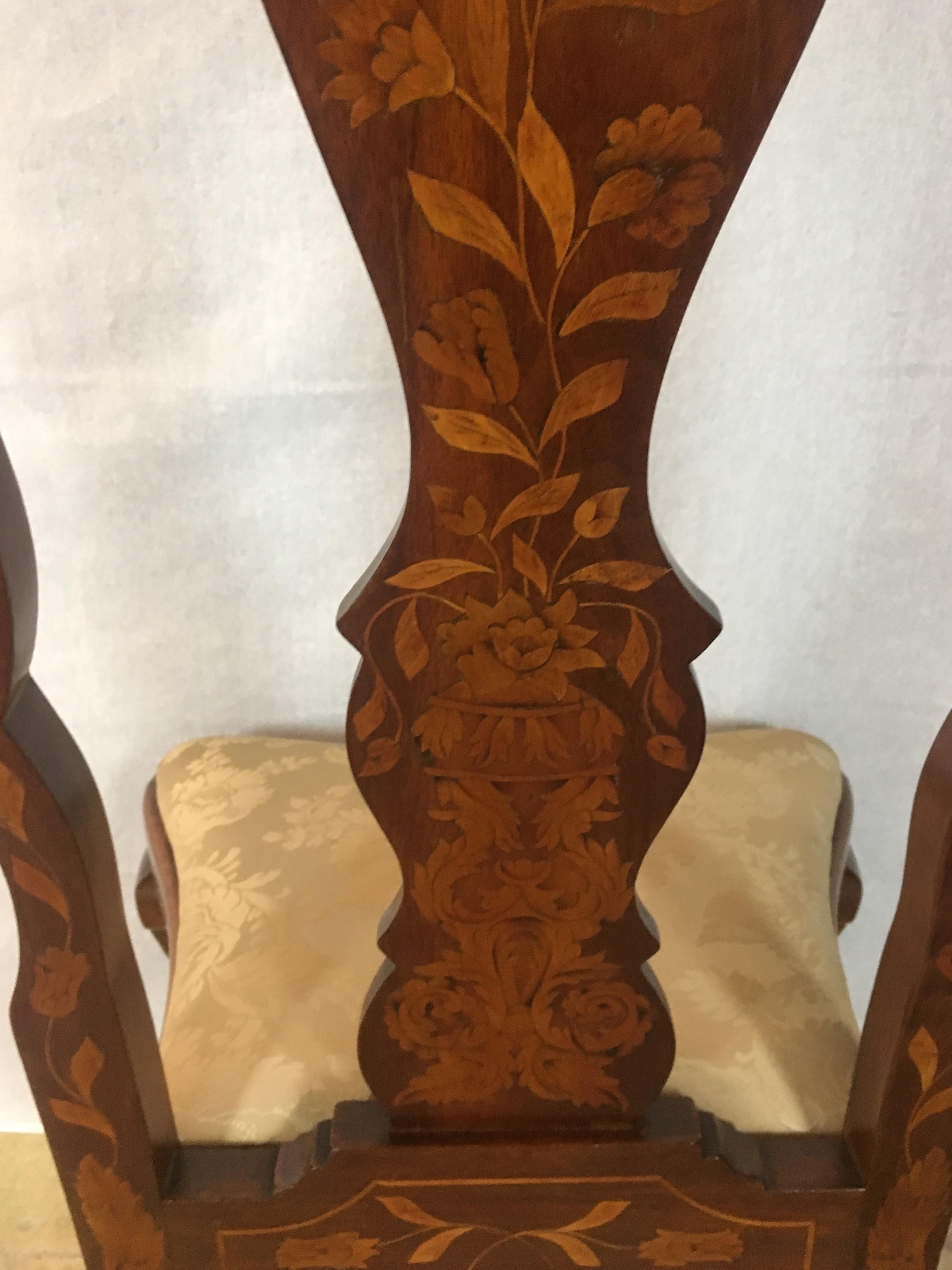 Very fine set of four 19th century Dutch walnut dining chairs in the Queen Anne style with vase shaped backs, all profusely inlaid with Dutch marquetry. The front legs of cabriole form. Superb exotic wood marquetry inlays overall depicting flowering