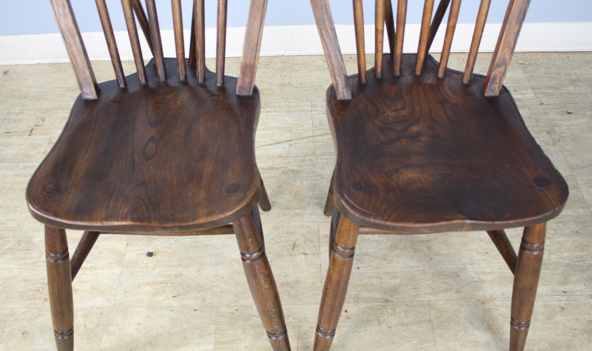 A set of four English elm Windsor chairs in very good antique condition. Although this is a like set, they are handmade, and the legs have slightly different flare, as shown in image #5. These would look wonderful around any number of table styles.