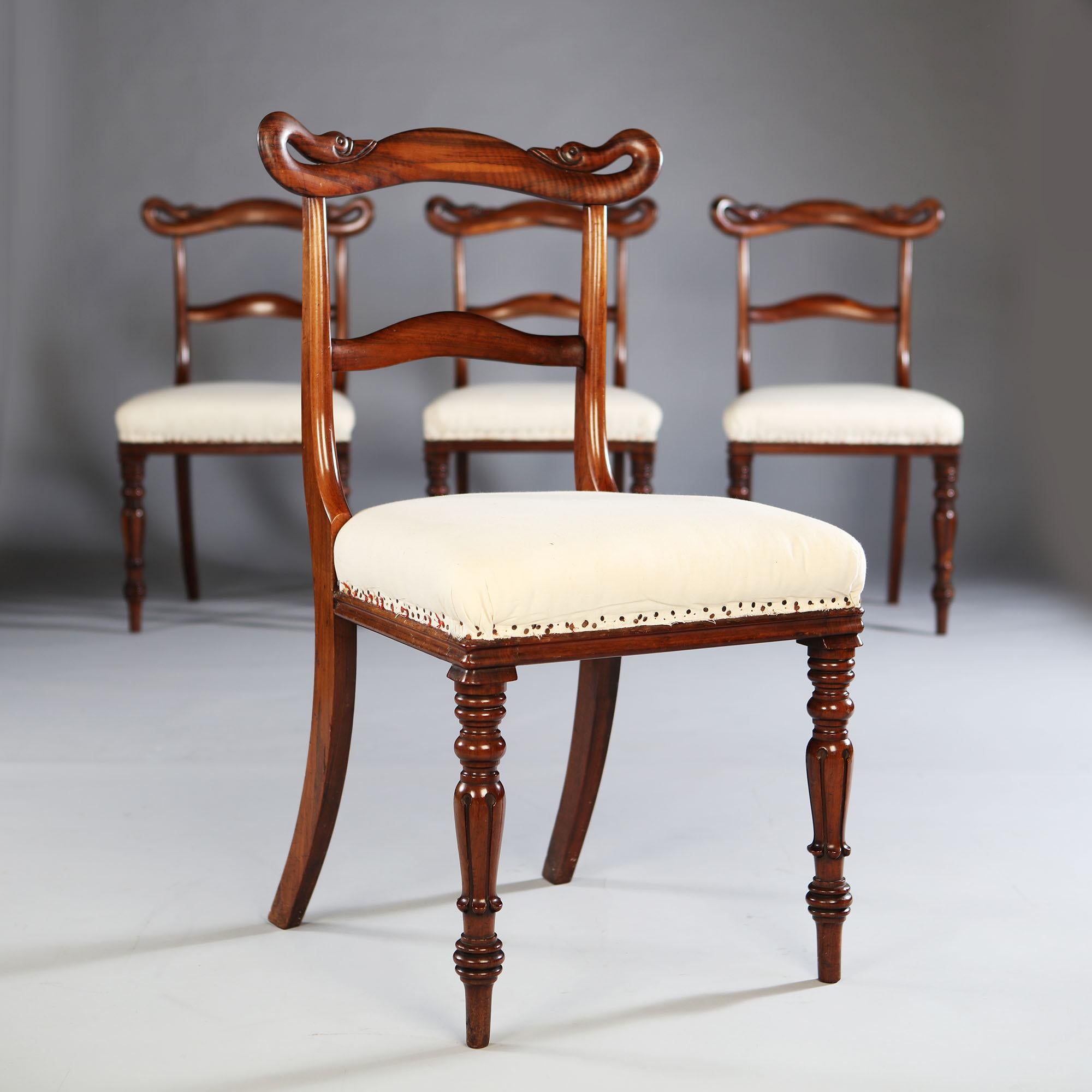 A set of four unusual Goncalo Alves side chairs, with scrolling swan necks to the back splats.