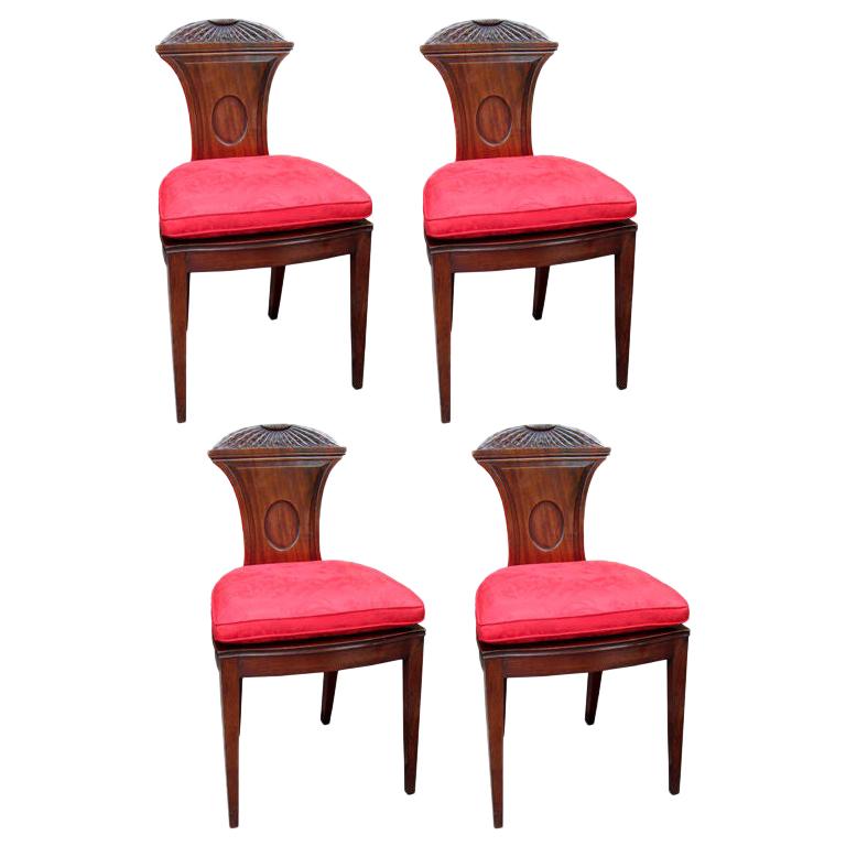 Set of four 19th century English mahogany hall chairs with chrysanthemum carving.