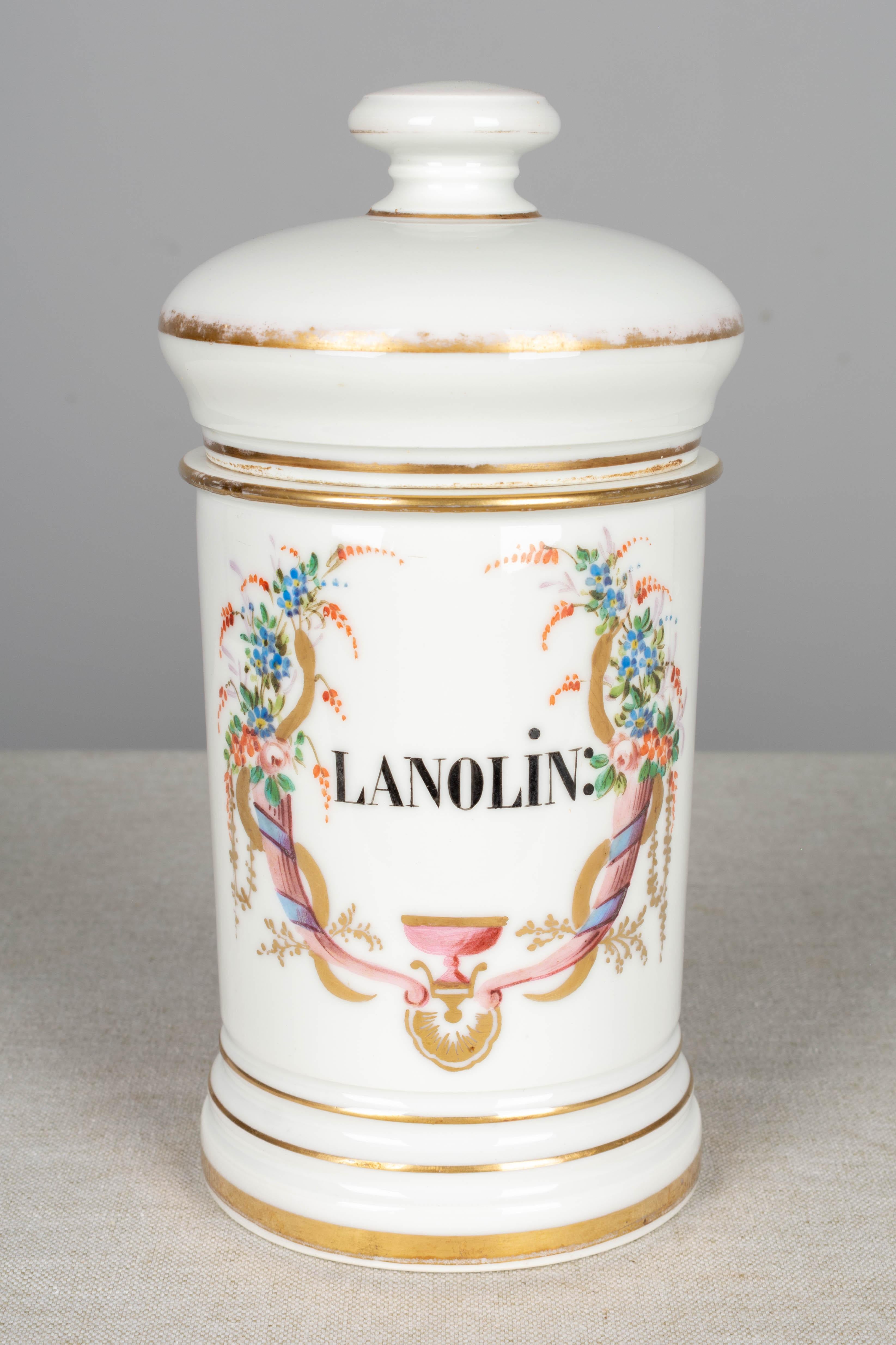 A set of four 19th century French Limoges style porcelain lidded apothecary jars with elegant hand painted floral decoration and lettering. Some of the gilt paint has rubbed off the lids. We have a total of 16 jars available, sold in sets of four.