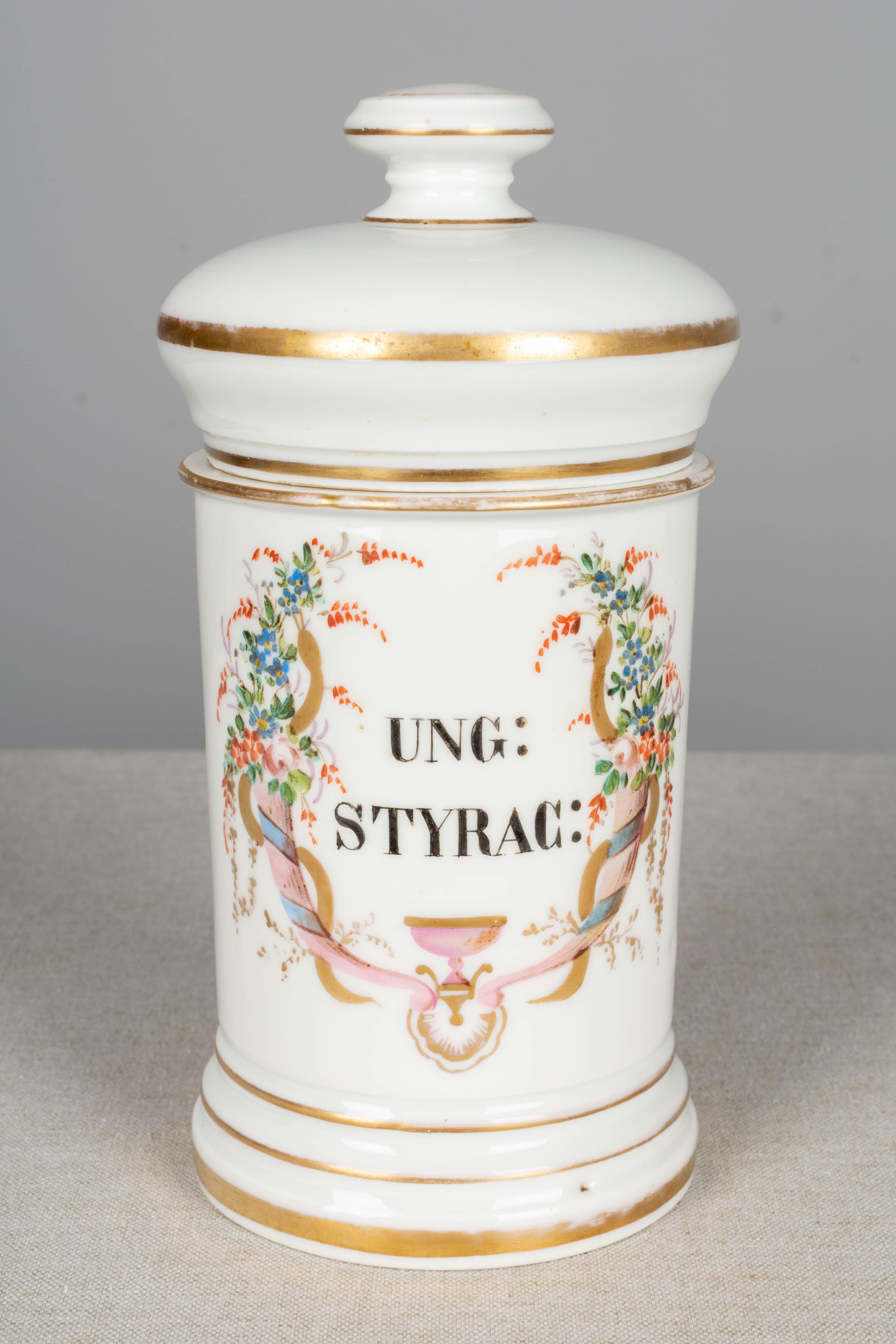 A set of four 19th century French Limoges style porcelain lidded apothecary jars with elegant hand painted floral decoration and lettering. Some of the gilt paint has rubbed off the lids. We have a total of 16 jars available, sold in sets of four.