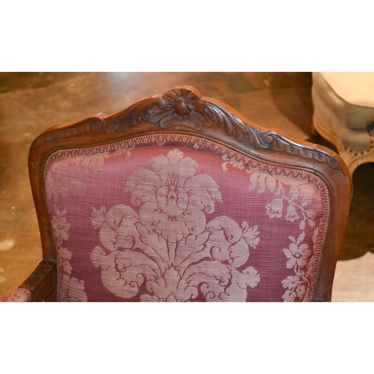 Exquisite set of four 19th century French Louis XV style open armchairs with silk brocade floral motif upholstery. The shaped crest rails beautifully carved with a shell and acanthus leaves. The contoured carved skirts flow smoothly to cabriole legs