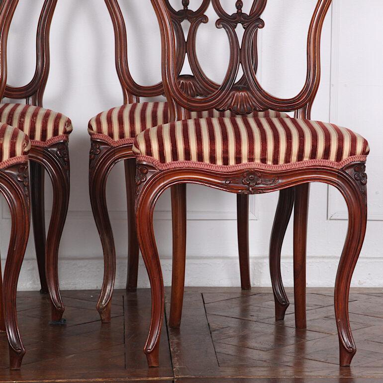 Set of four smaller-scale 19th century French chairs with elegant cabriole legs and finely shaped and pierce-carved backs. Although these are smaller chairs, they are extremely comfortable with just the right curve and angle to their backs.
 
