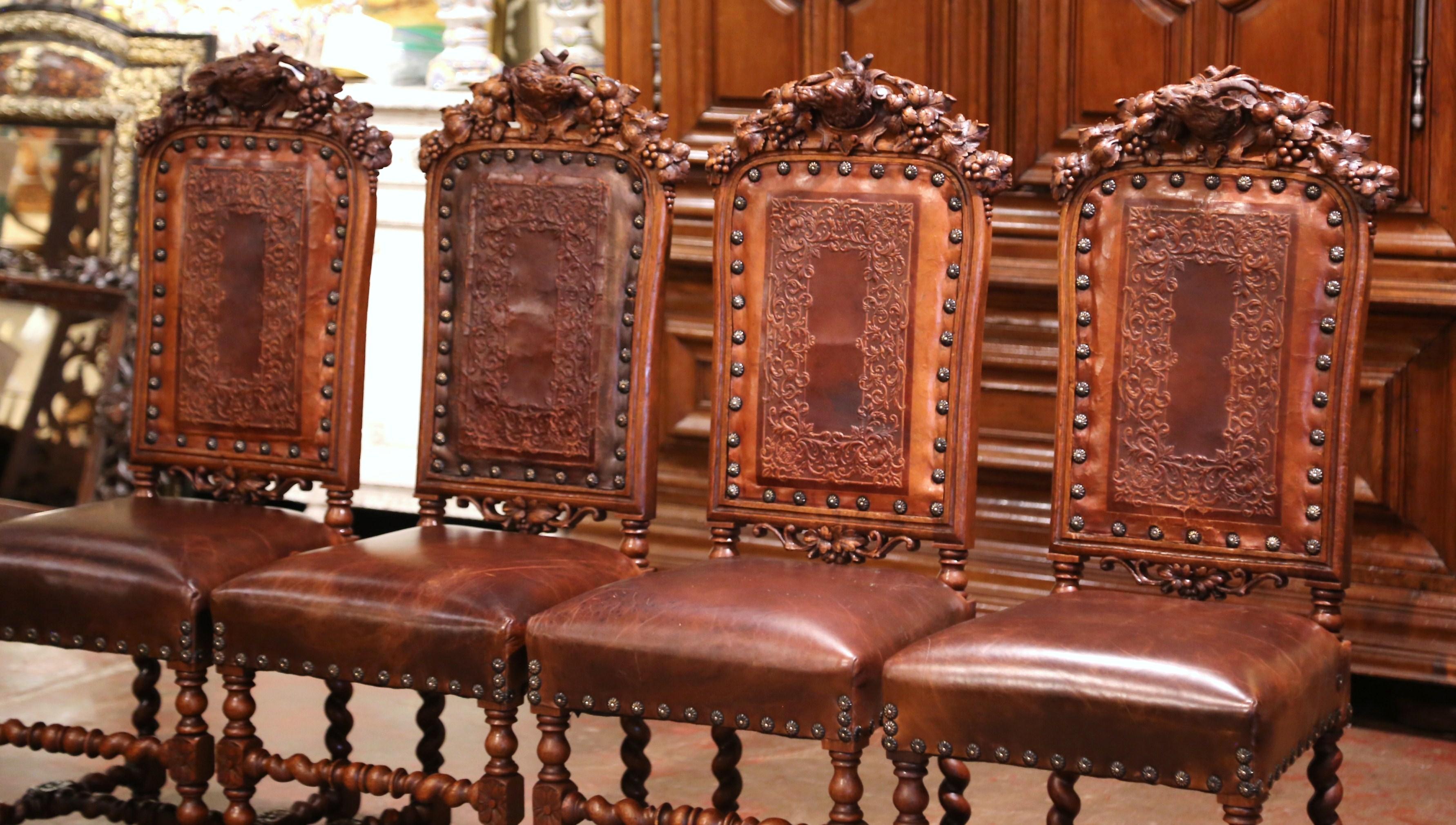 Decorate a wine cellar or dress a game table with this spectacular set of antique chairs. Crafted in France, circa 1860, each side chair stands on barley twist legs, decorated with an elegant carved stretcher. Each chair has exquisite carvings and