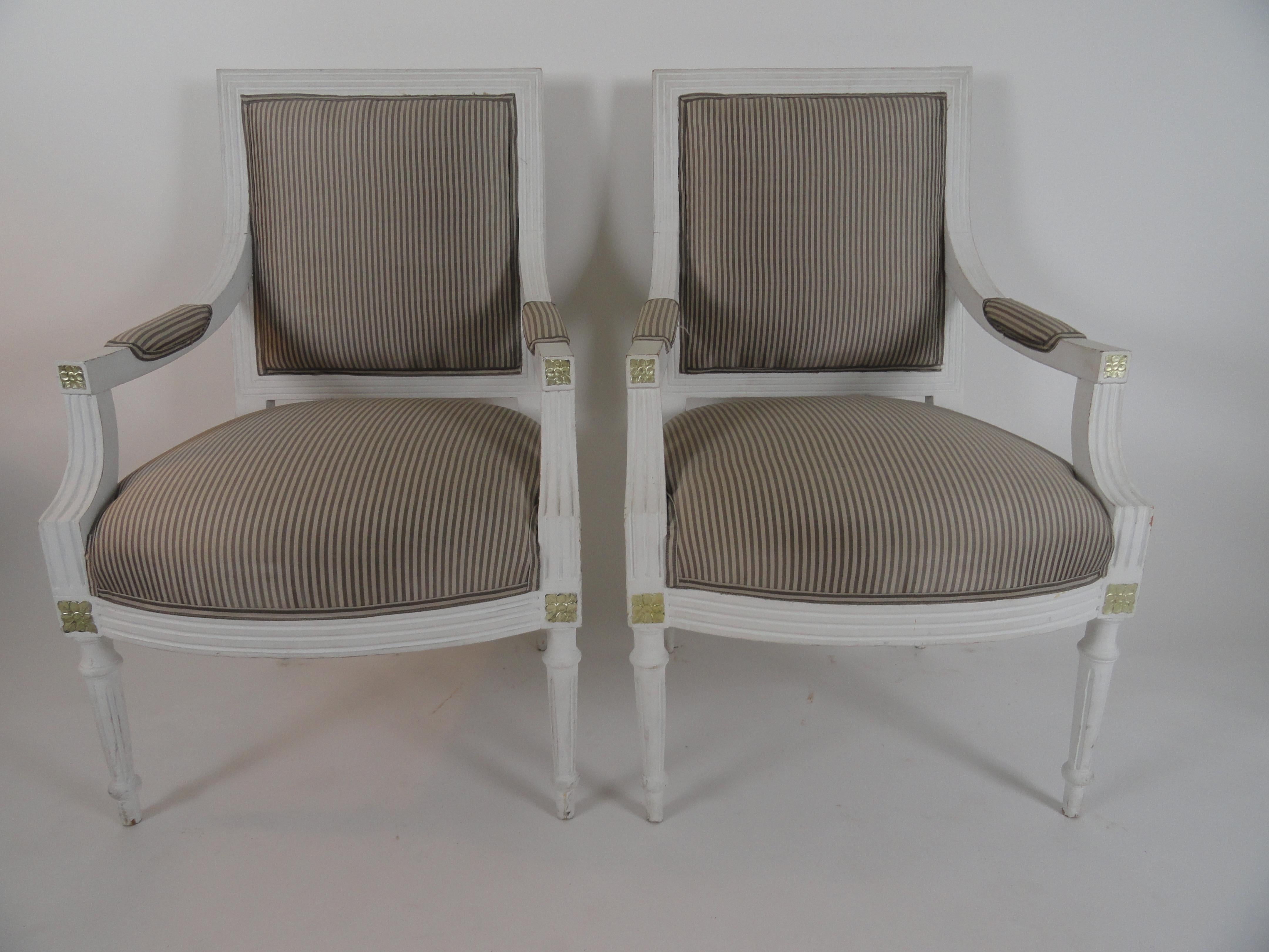 Very rare set of four Gustavian armchairs from the mid-19th century. Acquired from Angie Tyner Swedish Antiques. Newer finish with silk upholstery and silver leaf carving detail.