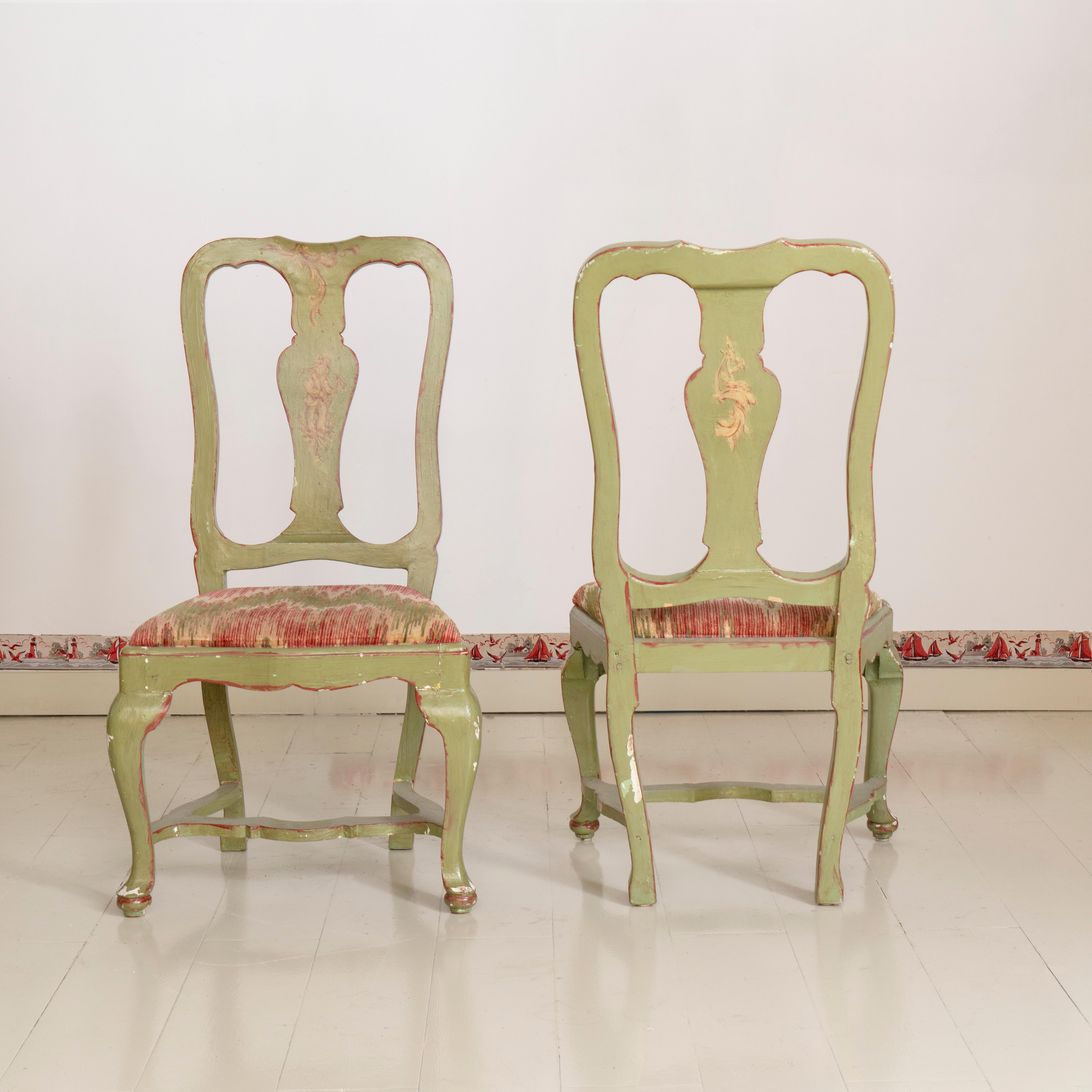 Set of four 19th century Italian painted chairs. Each chair has a light green background against a painted folk figure on the center splat.