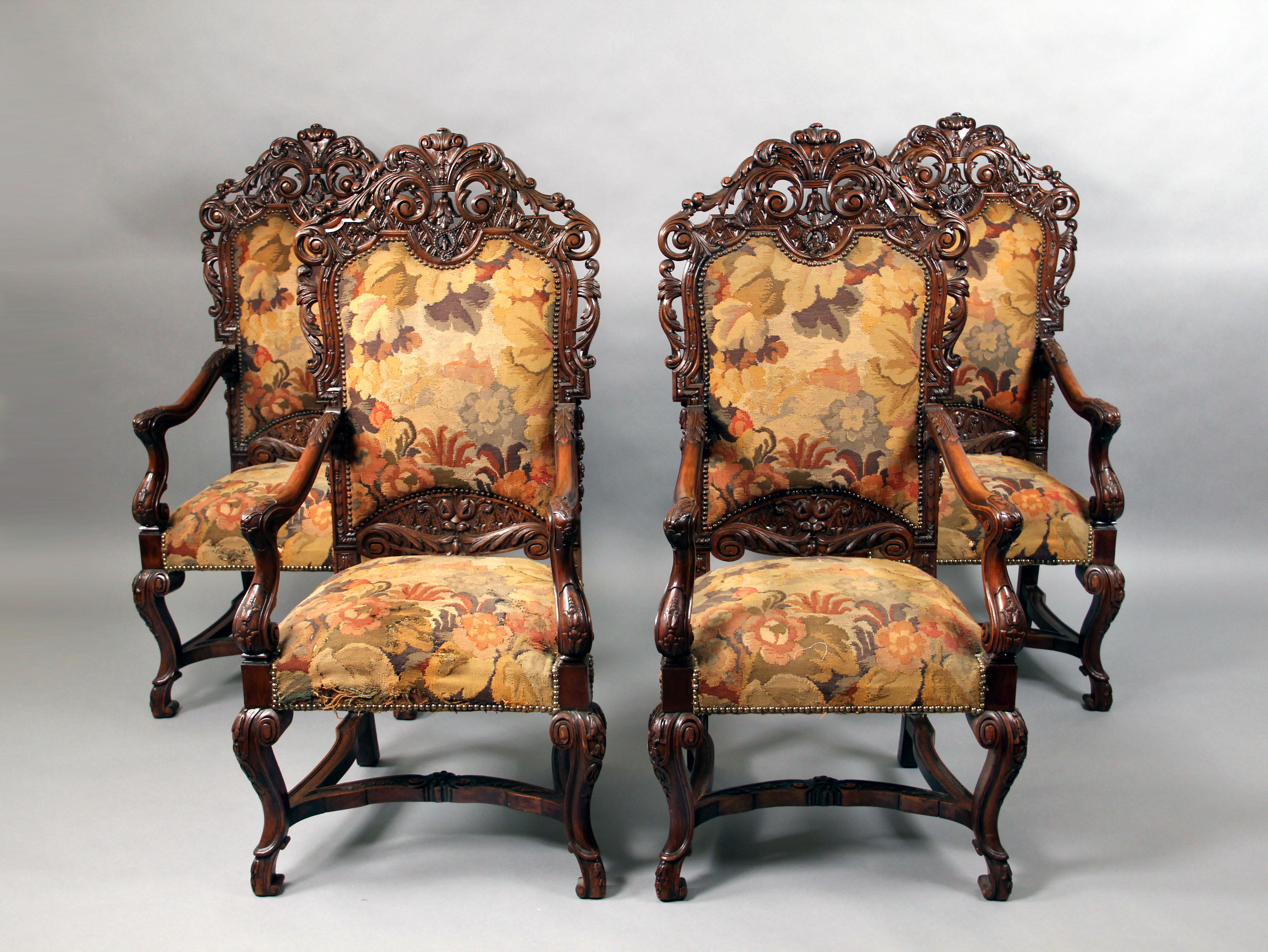 A set of four 19th century large hand-carved wood high back armchairs.

Wonderful quality carvings, standing on curved legs which are attached by a stretcher.