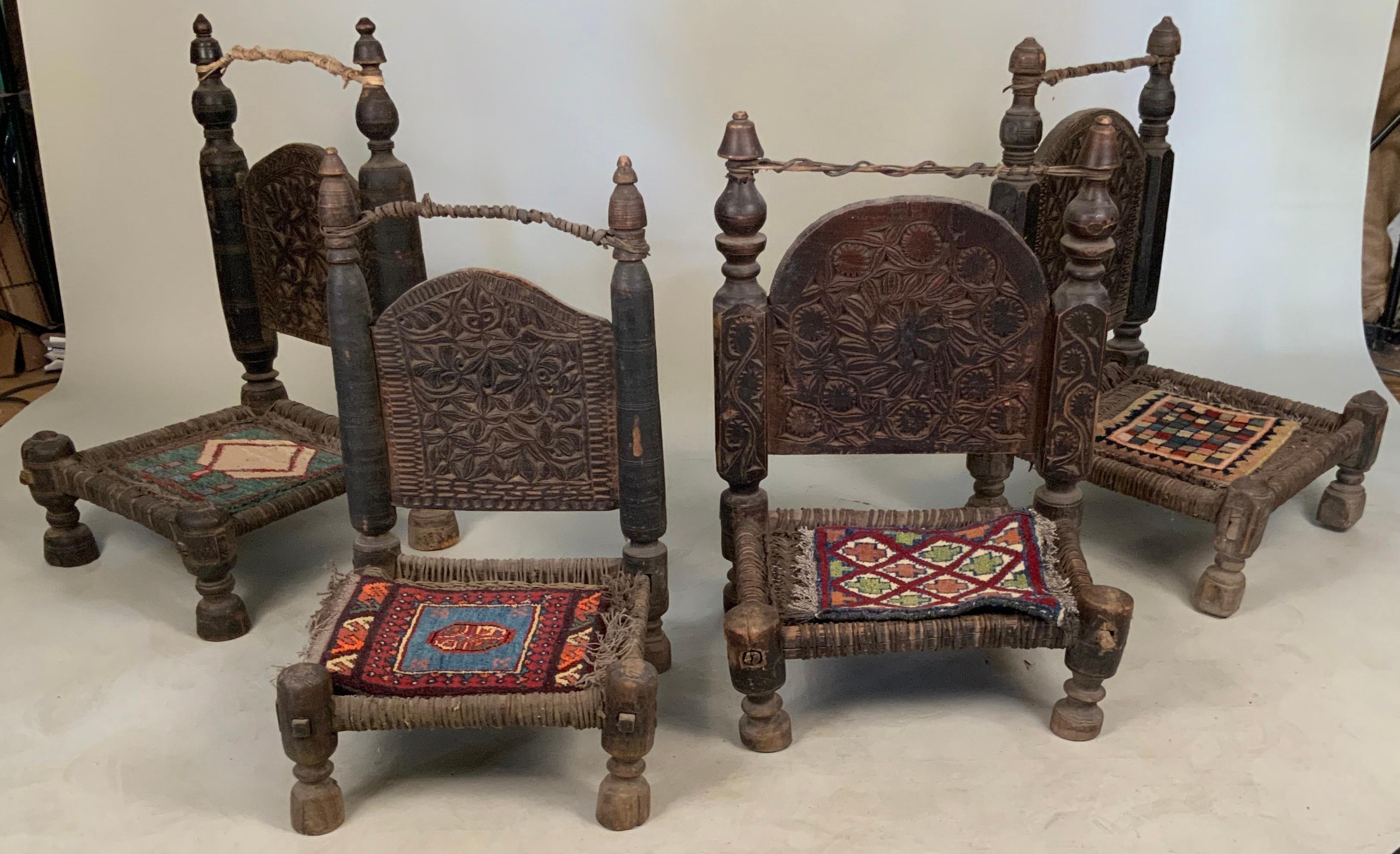 An amazing set of four antique 19th century tribal bedouin chairs from northern Pakistan, with amazing details and the original handwoven small carpet seats. together with their companion small square table.