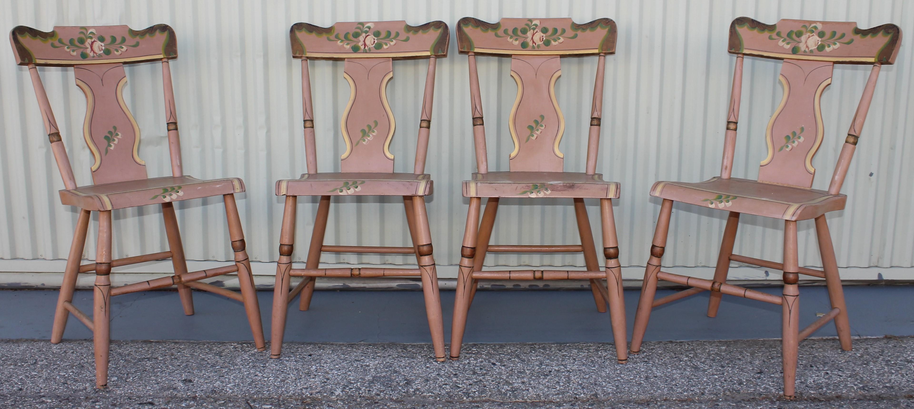 These chairs were found in Lancaster County, Pennsylvania and are in very good and sturdy condition. Beautiful set of four mauve colored hand painted plank bottom chairs with a floral design. Beautiful craftsmanship and elegant and stylish. All