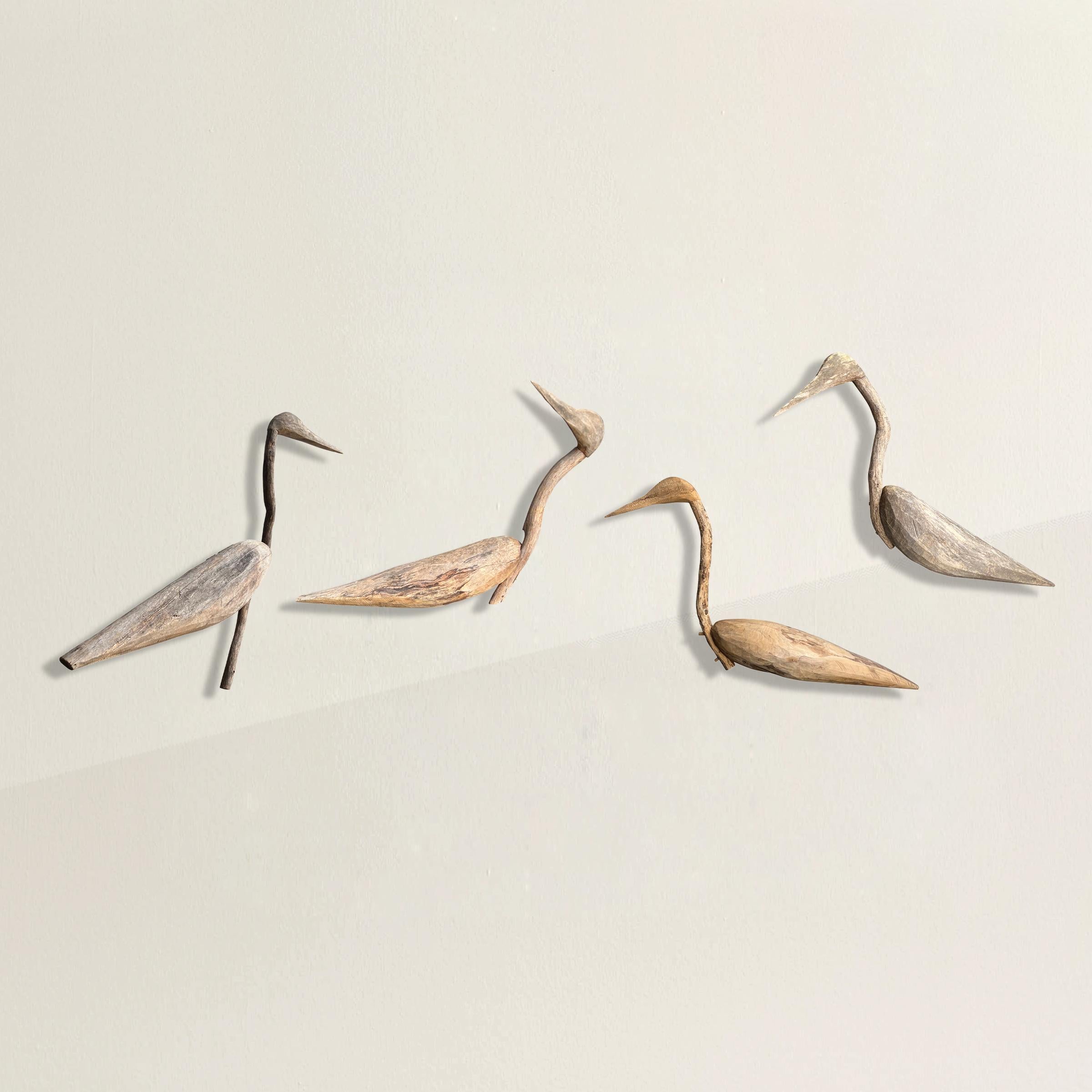 A spirited and playful set of four 20th century American Folk Art wood decoys each with hand carved bodies and heads supported by natural contorted branch necks that add instant individual personalities to each bird. We've had custom steel wall